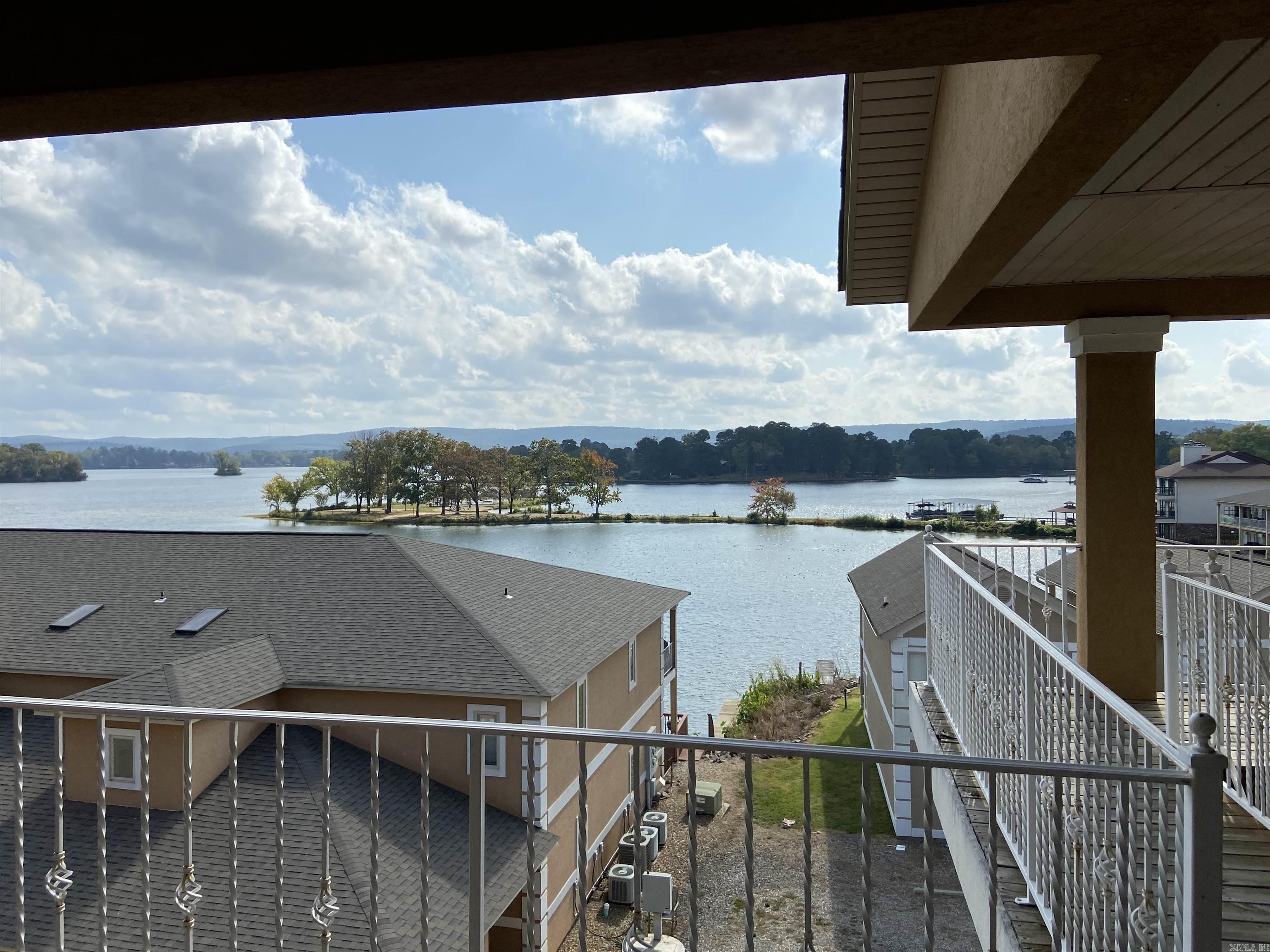 Don’t miss this wonderful 2 bedroom 2 bath corner condo overlooking Lake Hamilton.  This condo is located in the coveted 7 South area close to everything. This home offers an open floor plan with vaulted ceilings a fireplace and French doors opening up to the large deck. The primary suite has double vanities a walk in shower and a jacuzzi tub!  It also has access to the deck through the French doors. There is a fire pit to be enjoyed by all residents and a community boat tie up. Nightly rentals are allowed.