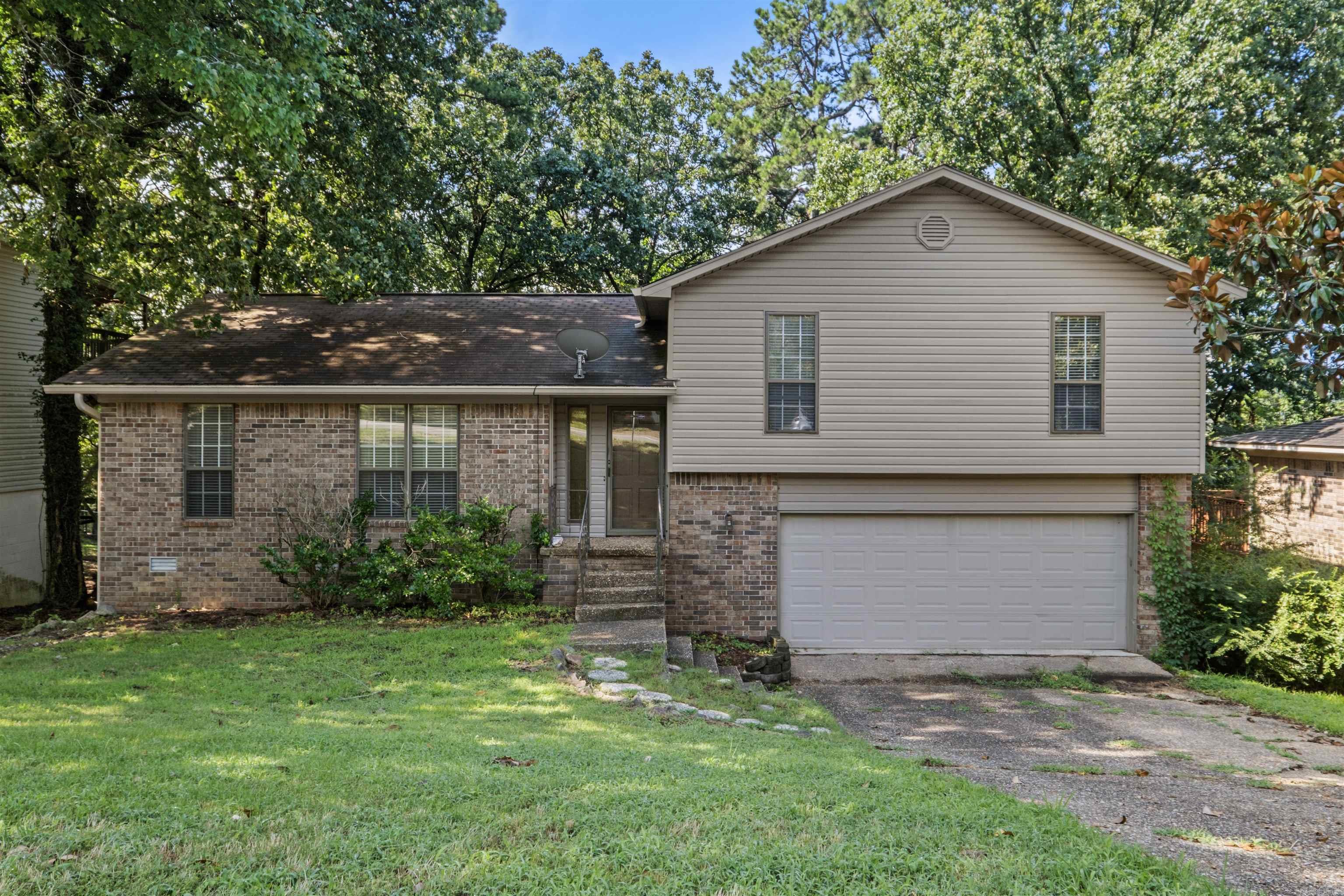 Welcome home to this inviting 3-bedroom, 2-bath split-level home, perfectly positioned in one of West Little Rock in Don Roberts School District. With newer siding and roof, this home offers charming curb appeal along with the added confidence of thoughtful updates. A newer HVAC system & updated water heater provide even more peace of mind. Inside, you’ll find a comfortable, functional layout designed for everyday living and easy entertaining. The home features two spacious living areas located just off the kitchen, offering plenty of room to gather, relax, create a cozy den, home office, or whatever fits your lifestyle best. All three bedrooms are conveniently located on the same level, while the laundry area is tucked away downstairs off the garage and door to the backyard  Enjoy newer LVP flooring throughout the bedrooms & beautiful hardwood flooring in the main living spaces, with absolutely no carpet to worry about! Outside, the back deck overlooks a private treelined backyard, creating a peaceful setting for morning coffee, weekend cookouts, or unwinding at the end of the day. This well-maintained home is full of comfort, flexibility, and potential! Agents see Remarks