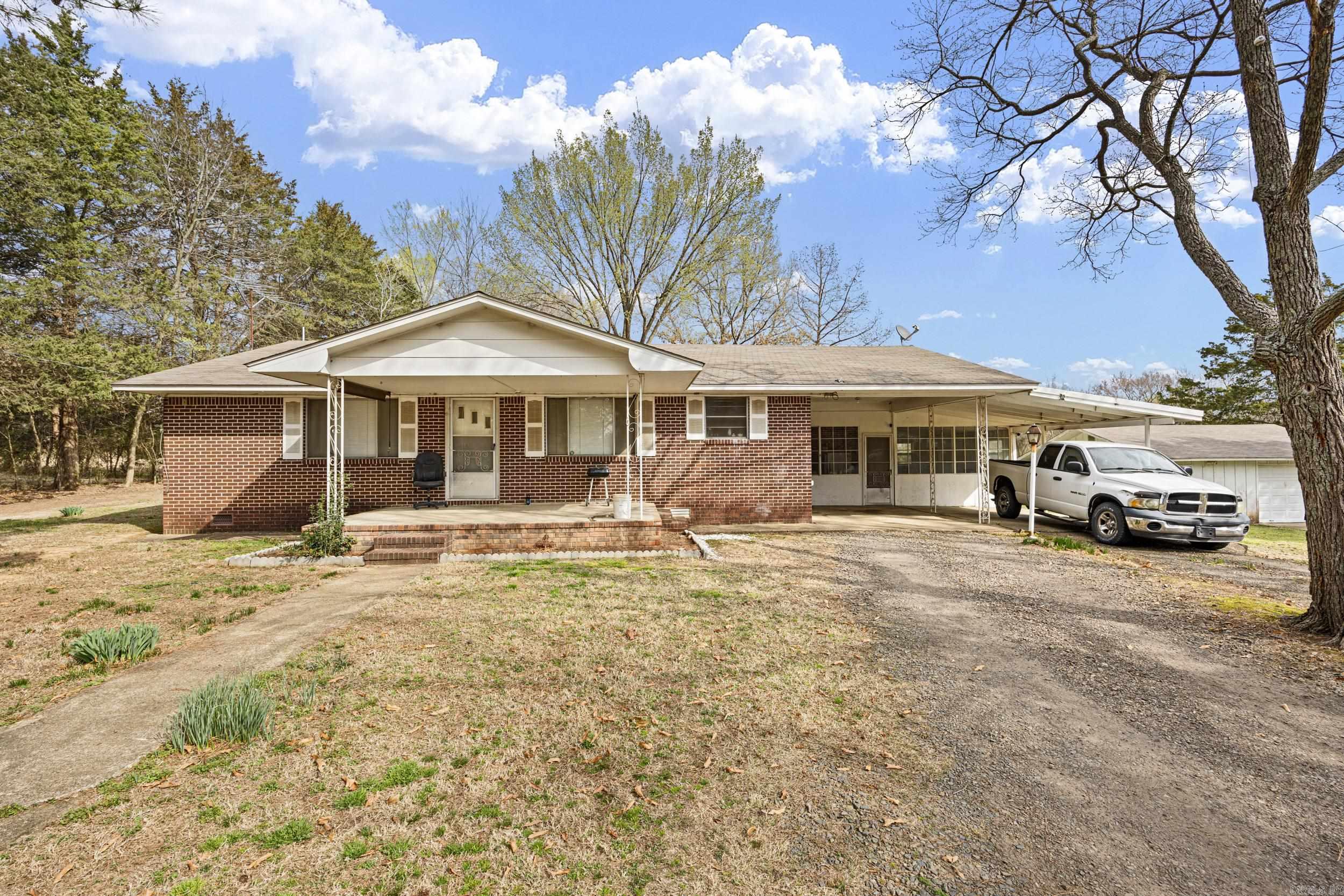 If you are looking for a home in the country with few acres under $200,000 look no further! This 3BR/1BA home features a bonus room, plumbed and ready for you to finish out. Large open floor plan, which is rare in the older home, with lots of storage space as well. Home is connected to rural water and has a wonderful well, also!  a large shop area with an attached lean-to for storing equipment in the dry.   A large pole carport sits just away from the house, which would fit a tractor perfectly. What would you need a tractor for, you may ask, for the 8.64 acres of land that comes with the house, of course. The land is a good mix of pasture and wooded area. Lots of game, including deer and turkey. New septic tank and lines
