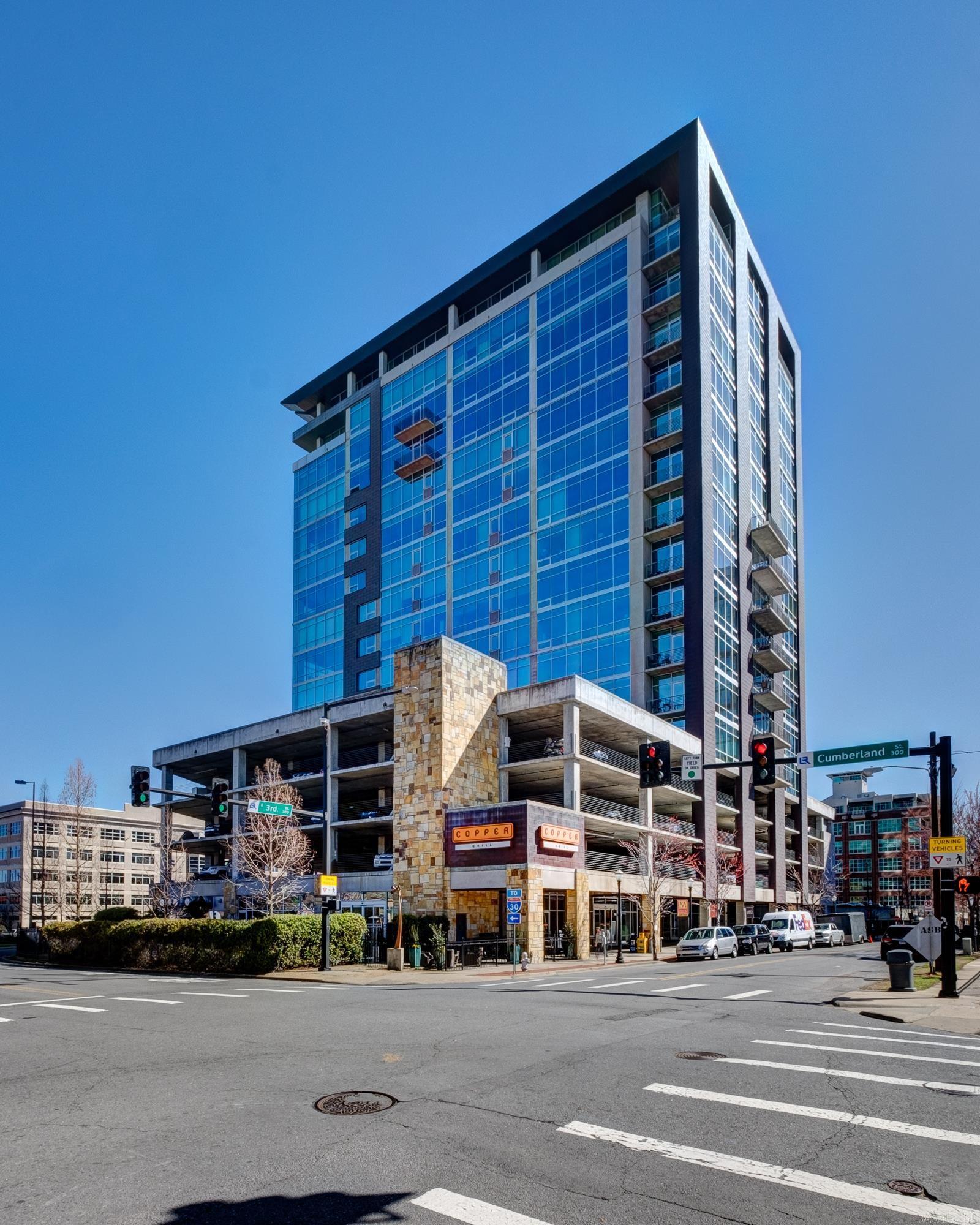 Modern Downtown Little Rock Condo — Urban living in the heart of Little Rock! Welcome to effortless downtown living. This renovated one-bedroom, one-bath condo delivers modern updates and unbeatable convenience. An open, light-filled layout is anchored by a dramatic floor-to-ceiling wall of east-facing windows, flooding the space with morning sunrises and skyline views. The updated kitchen features neutral contemporary finishes for everyday cooking and entertaining. Storage throughout includes abundant extra closet space. Wonderful building amenities such as concierge, gym, pool, hot tub, rooftop common areas and with Copper Grill restaurant right downstairs, your next great meal is just an elevator ride away. One covered garage parking space included. Walk to restaurants, entertainment, the River Market District, and everything downtown Little Rock has to offer.