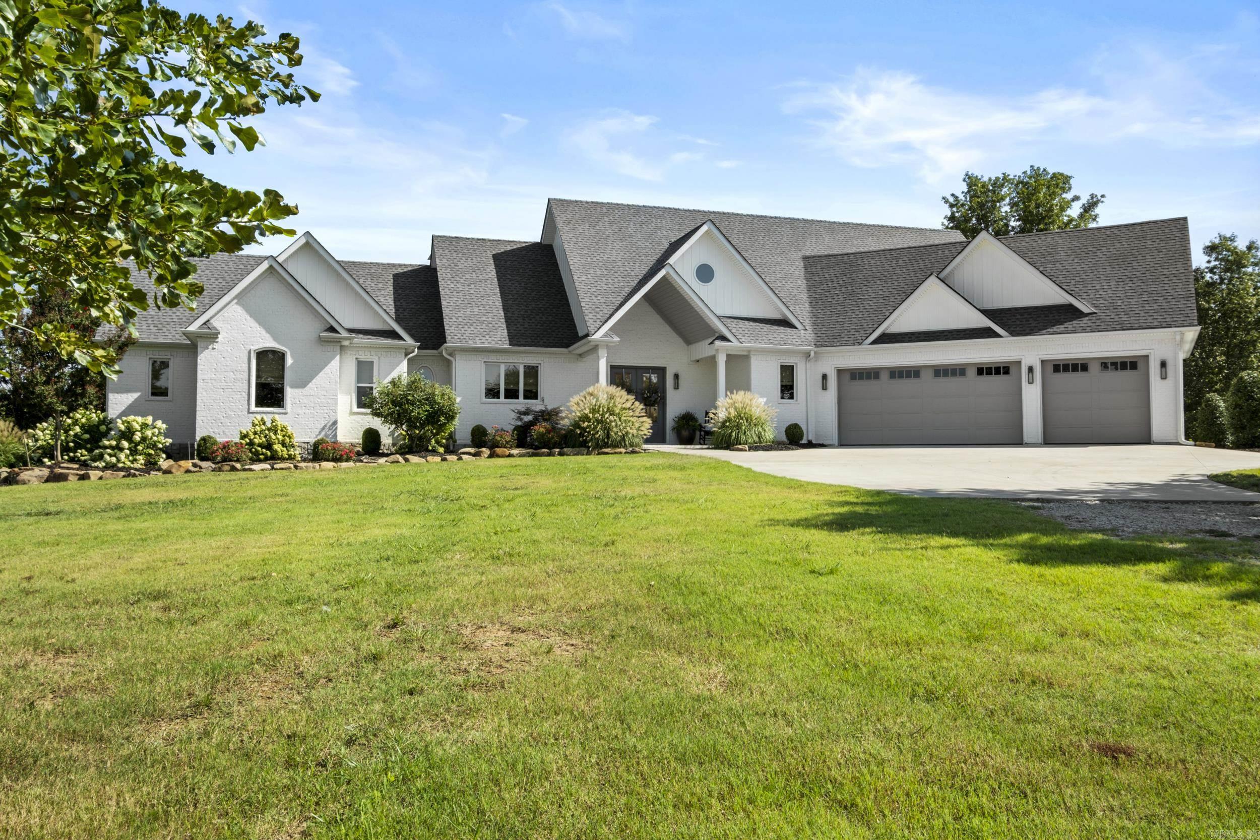 Custom built home w/premium amenities throughout.  Open floor plan provides easy flow from kitchen / dining to the living area which offers a cozy gas fireplace flanked by built ins. Office area off the living room. Half bath main level. Gourmet kitchen features quartz countertops, double ovens, six top gas burner stove, farmhouse sink, undercounter microwave & the island is a chef's dream.  Living area has lots of windows & 3 sets of French doors leading to the outdoor entertaining area complete with views of the pond.  Surround sound system from inside the home and out to the large covered patio.  Primary suite features a walk in closet w/built ins including a vanity area.  Oversized walk in shower in primary suite plus soaking tub complete this deluxe suite.  Safe room located on main level in the guest room which has ensuite bath. Sprinkler system. The shop is an outdoor enthusiast's dream with Over 3900 sq ft. Roll up doors on each end.  W/D hookup.  Half bath.  Cedar closet.  Lofts w/stairs on each side.  Two storage rooms (could be office). Lean to on each side.  RV hookup outside shop.  20 acres is apprx 1/4 timber covered.