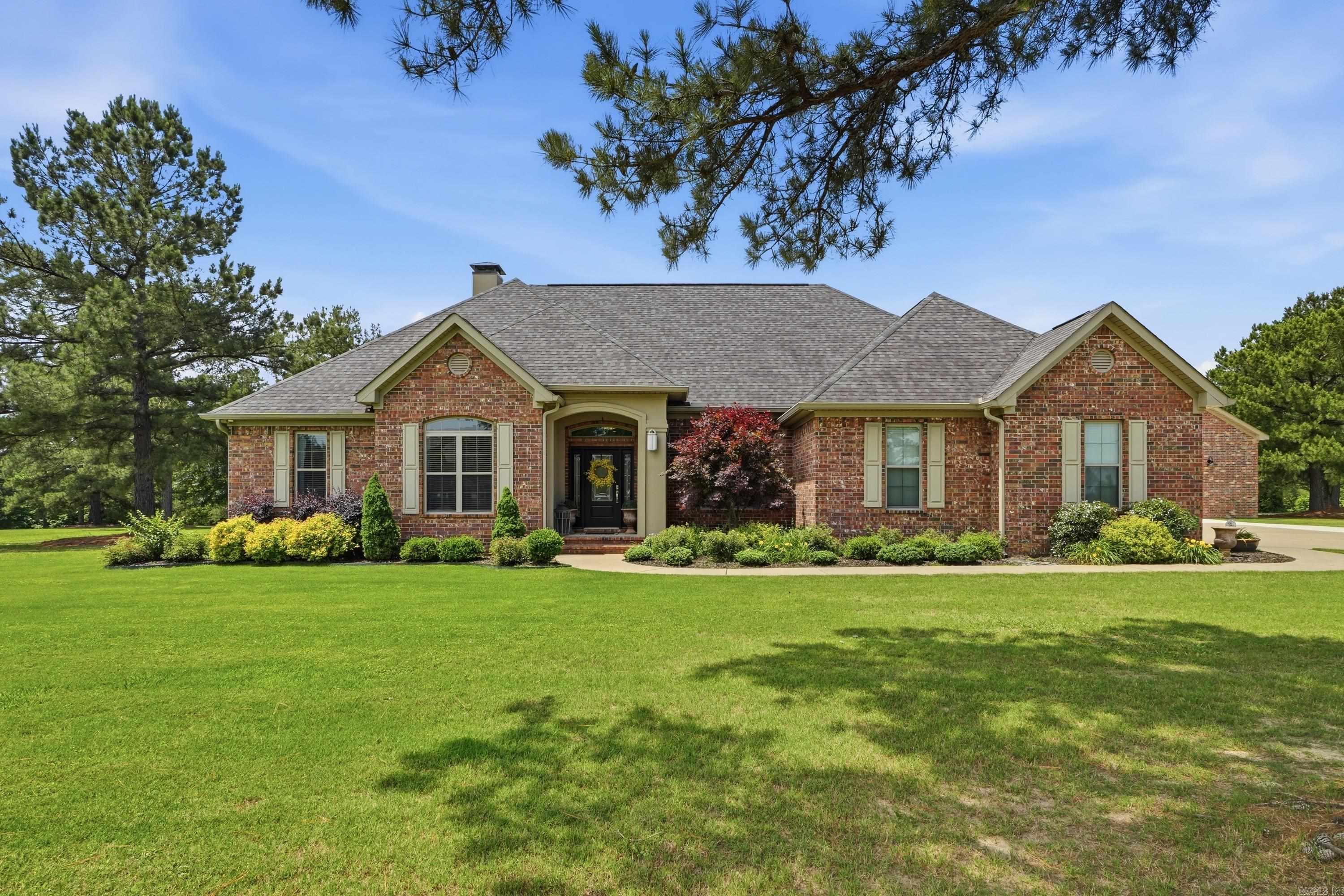 Discover your dream home in this prestigious neighborhood in the East End Community of Saline County! Just a 20-minute drive from Downtown Little Rock, this exceptional property is within one of Arkansas's top school districts. With 4.53 acres across three separate lots, it offers flexibility & is ideal for building a family compound, additional homes, or future investment. The main house has 2,417 square feet, featuring 4 bedrooms & 2 bathrooms. Experience the luxury of an open floor plan w/ high ceilings, elegant woodwork, & expansive windows. Entertain in style w/ a formal dining room & a spacious living area complete w/ a fireplace. The kitchen is a chef's delight, offering granite countertops, beautiful cabinetry, & an island bar. Enjoy the privacy of a split floor plan w/ a primary bedroom suite that includes separate closets. A charming guest house w/ a bedroom, kitchen & bathroom connects to a fully-brick, 50 x 30 heated & cooled shop w/ a 10-ft overhead door. Explore the beautifully designed outdoor living areas that offer stunning views of the backyard, complete with an inground pool. This property also features a 22kW whole home generator. Let's schedule a tour today!