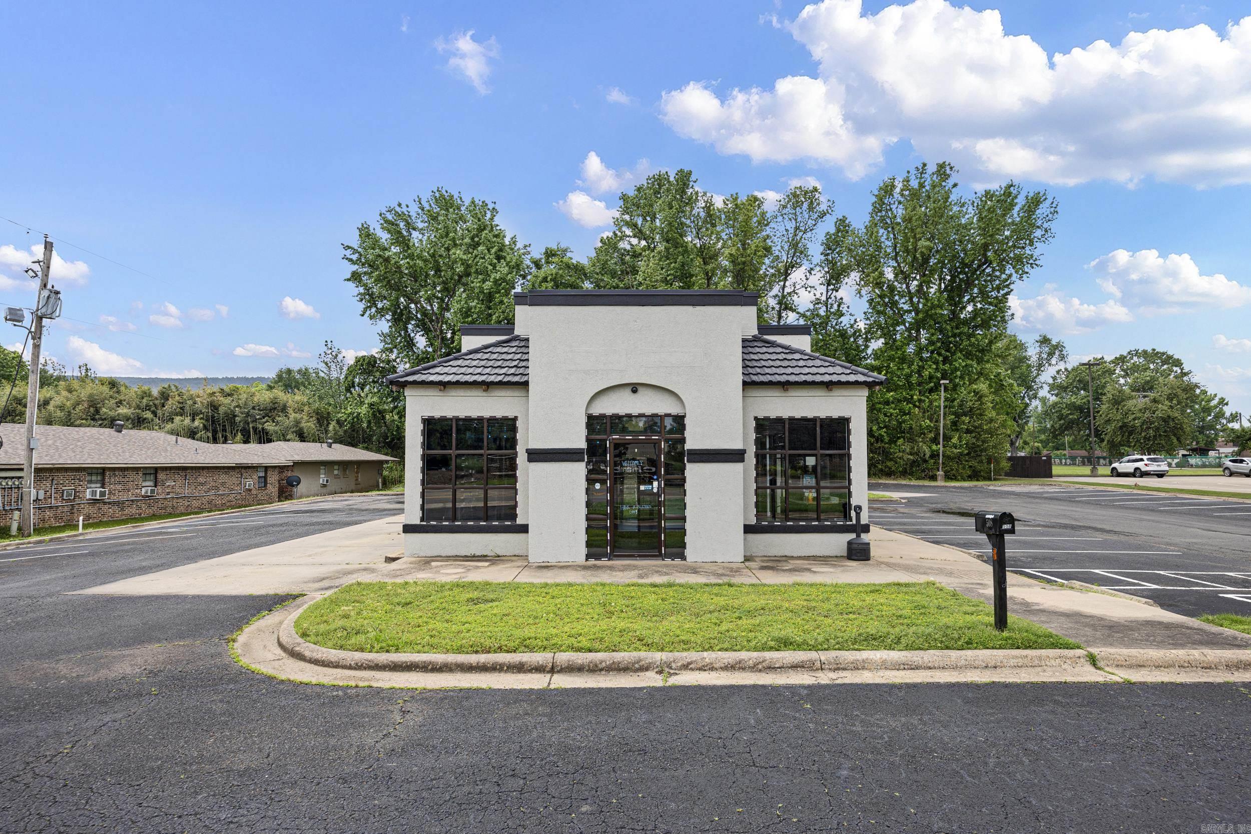 Prime commercial opportunity in a high-traffic, central location. This recently renovated 1,604 sq ft building offers excellent visibility and versatility, formerly operating as a smoke shop and previously a restaurant—making it well-suited for a variety of business uses. Positioned in the heart of town, the property is within walking distance to the high school and directly across from the hospital, providing consistent foot and vehicle traffic. Features include existing walk-in refrigerators, a drive-thru window, a bathroom, dedicated office space, and a spacious paved lot with ample parking. Ideal setup for restaurant, retail, or service-based business with strong potential for redevelopment or continued commercial use.