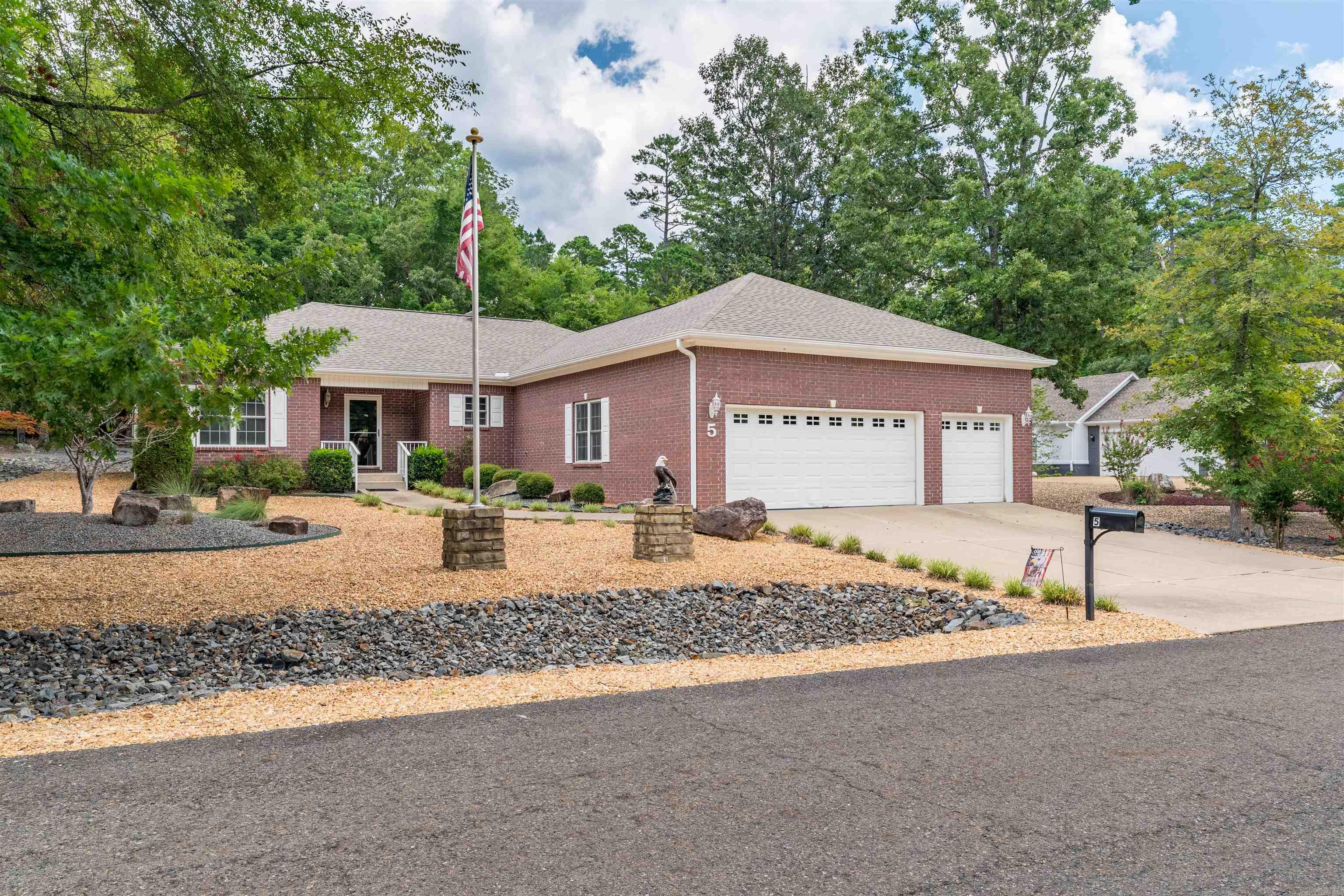 Move in ready home located on the East End of Hot Springs Village.  This updated 3-bedroom, 2 bath home features low maintenance luxury vinyl flooring; a large central kitchen with quartz countertops, premium GE Cafe appliances, new cabinetry, double ovens and a dual fuel range; lots of windows for natural light; and custom ceilings.   The interior has been recently painted and a new 30 architectural roof in July 2026 adds long-term confidence.  For added assurance, the Sellers installed a 4 ton 2 stage 15.2 sear heat pump in 2024 that has a 10-year parts warranty.  You'll appreciate the 3-car garage plus a large storage/workshop room that provides exceptional utility (See floor plan for room measurements).  Outside you will find a covered patio and 3 raised beds, perfect for vegetables, herbs, or flowers.  The yard offers a great blend of low-maintenance living with space to grow and enjoy the outdoors.  Come see all that this lovely home has to offer!