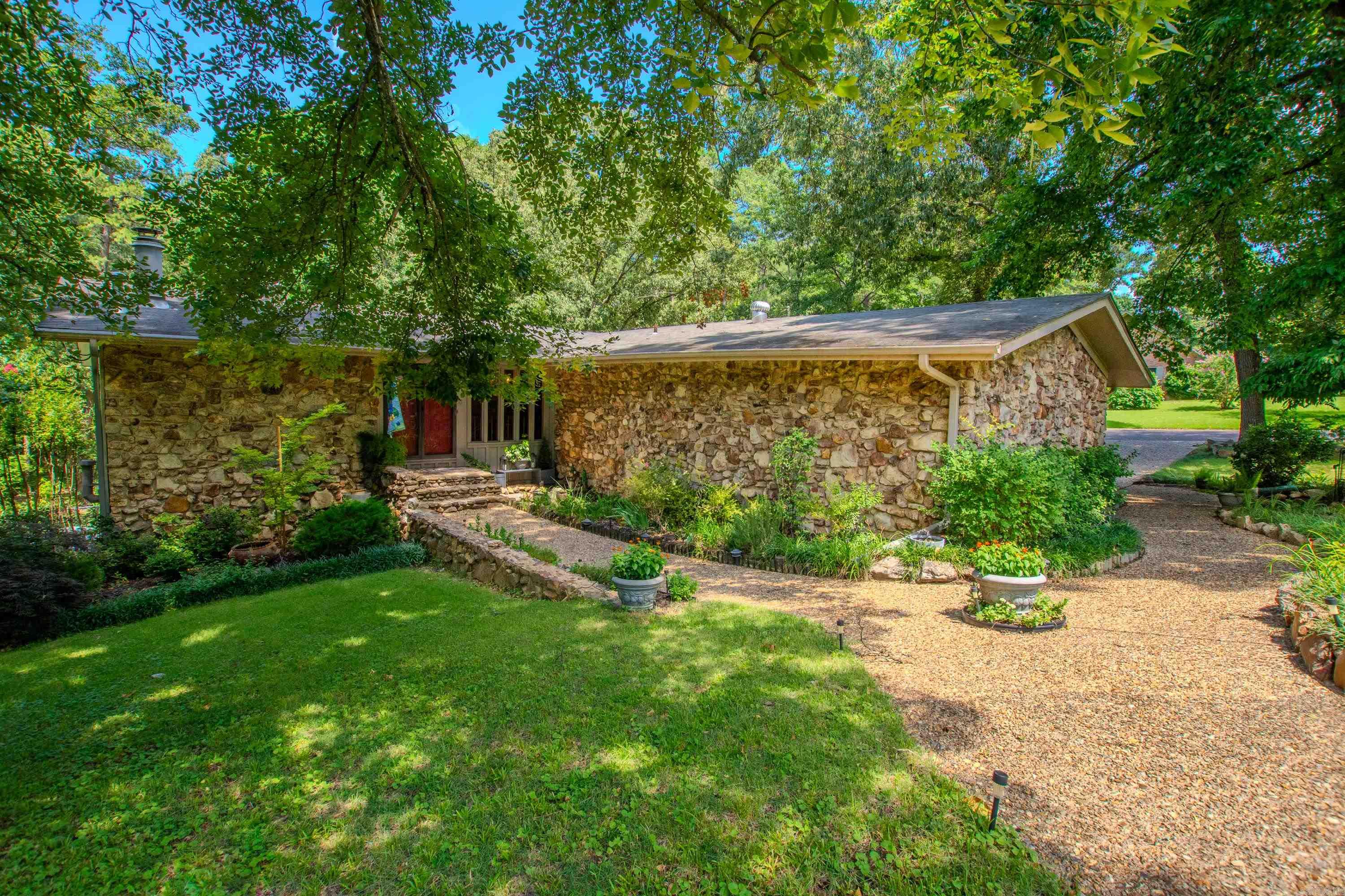 This Beautiful home sits on 2 manicured city lots with small greenhouse, storage shed, motorhome parking pad, playground, extensive landscaping with new lower patio & 2 car side load garage. 4 Bedrooms, 2.5 Baths, updated Kitchen with large island, open Dining/Living area, Master Suite with updated Bath & access to patio, Office, Laundry, lots of storage, large windows, Deck, Patios, Built Ins & so much more. All this within 3 blocks to Howard Perrin School & Quick easy access to I-30, shopping, restaurants & more. Check out all the landscaped walkways & shaded secluded sitting areas.