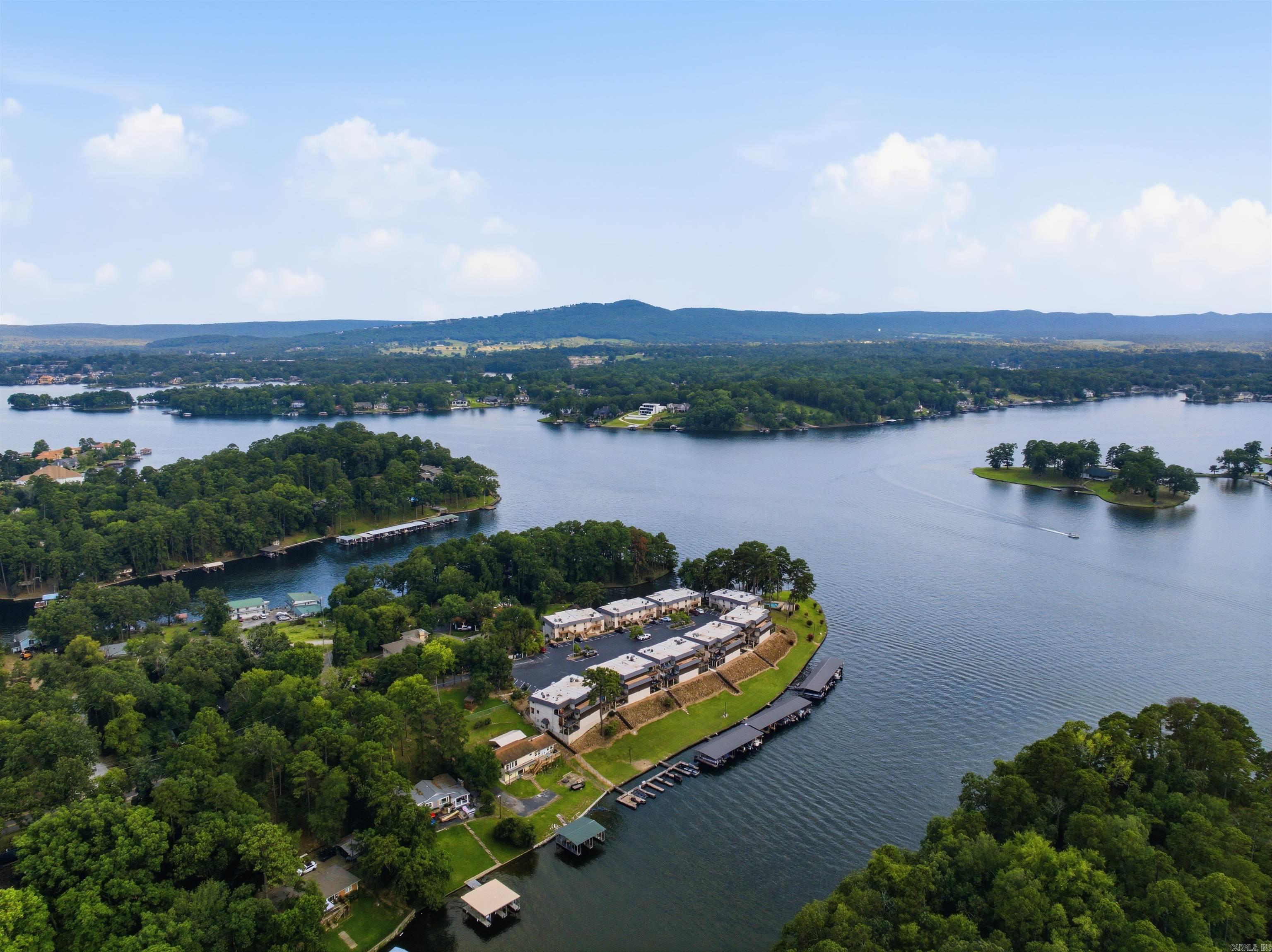 This 2-bedroom, 2-bath condo is the definition of turnkey. Sold completely furnished and located in a gated community with its own boat slip, it’s ready for weekends at the lake from the moment you close.  Spend your mornings on the balcony, your afternoons on the water, and your evenings watching the sunset. Whether you’re looking for a weekend retreat, or a full-time residence, this one offers the kind of convenience that’s hard to find on Lake Hamilton.