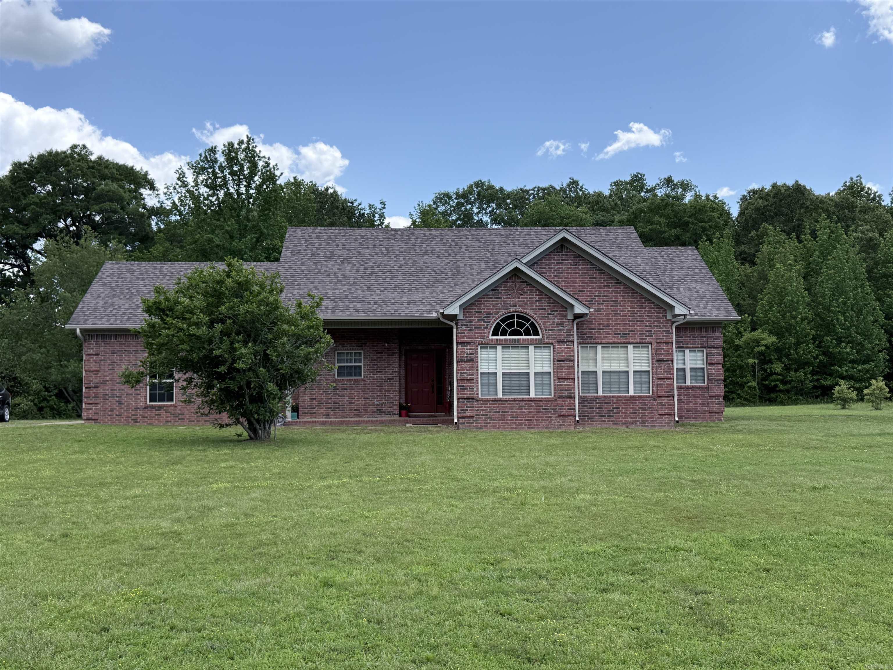 Country living at its finest in this all-brick 3-bedroom, 2-bath home on just under an acre in Austin. Featuring updated flooring, fresh paint, new fixtures, and a cozy wood-burning fireplace, this home offers comfort and charm throughout. The spacious primary suite is tucked away at the end of the hall and includes a jetted Jacuzzi tub, separate shower, double vanity, and generous closet space. Enjoy peaceful surroundings, mature trees, and plenty of room to spread out while still being conveniently located.