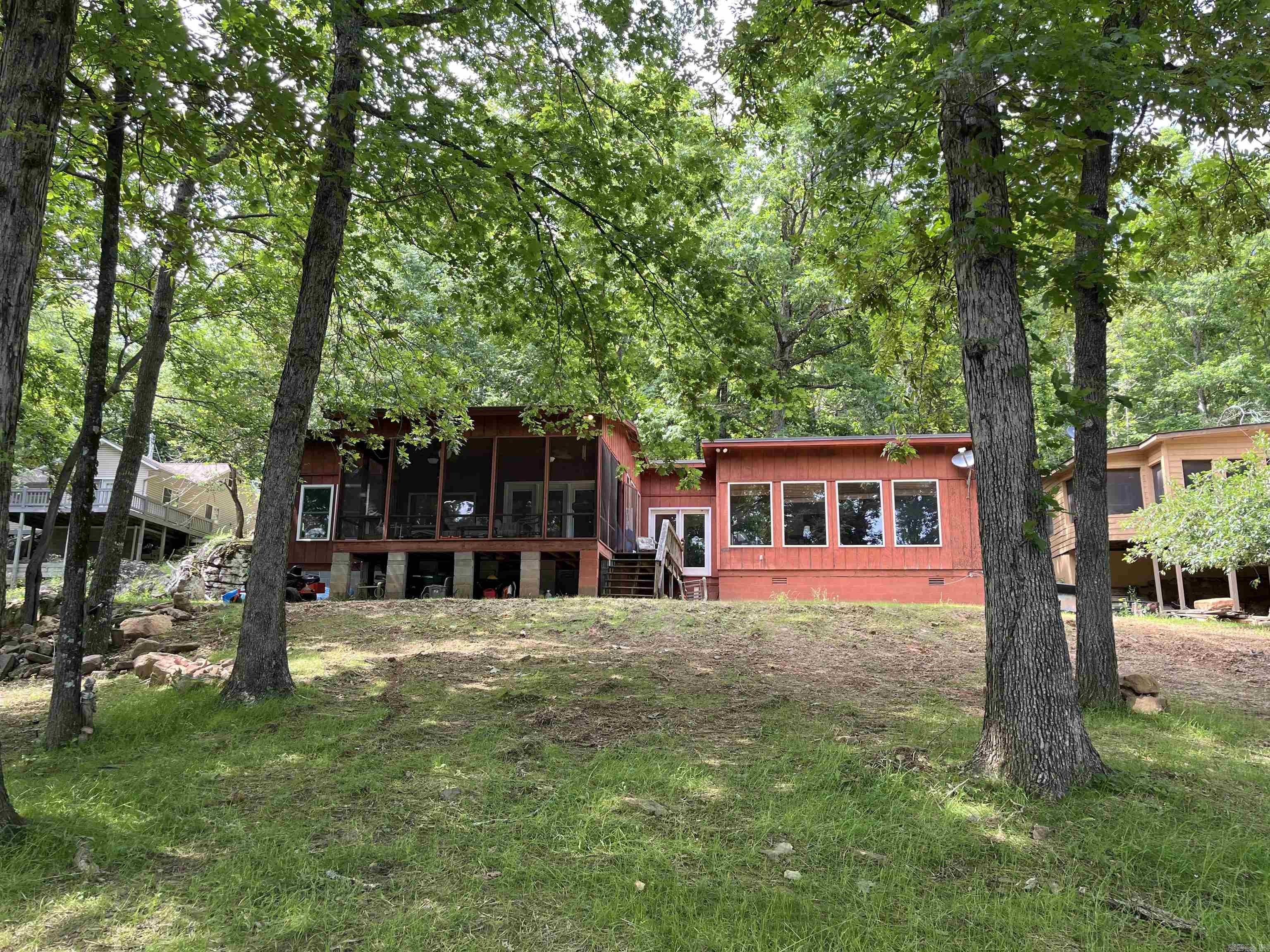 Have you ever dreamed of living your best life by the lake? That dream can become a reality with this lakefront property. From almost every room in the home—and even outdoors—you’ll enjoy breathtaking views of the water. Just minutes from Hill Creek Marina, right on Greers Ferry lake and just a short distance to the sweet little town of Greers Ferry . Boat right up to your back yard. Located in a more intimate part of the lake with less traffic. Start your mornings on the screened porch, sipping coffee while soaking in the serene beauty of the lake. The peaceful atmosphere here never gets old. This 3-bedroom, 2-bath home offers plenty of room to relax and entertain. Extensive landscaping has been done to enhance the outdoor space. Don’t miss your chance to own this slice of lakeside paradise.  All Main Furniture stays with the Property if desired    The Roof was recently upgraded to metal a few years back, New Septic system was installed in April 2025 , Spare Bathroom recently received new floors,  vanity and Toilet in October 2025  *see Agent Remarks