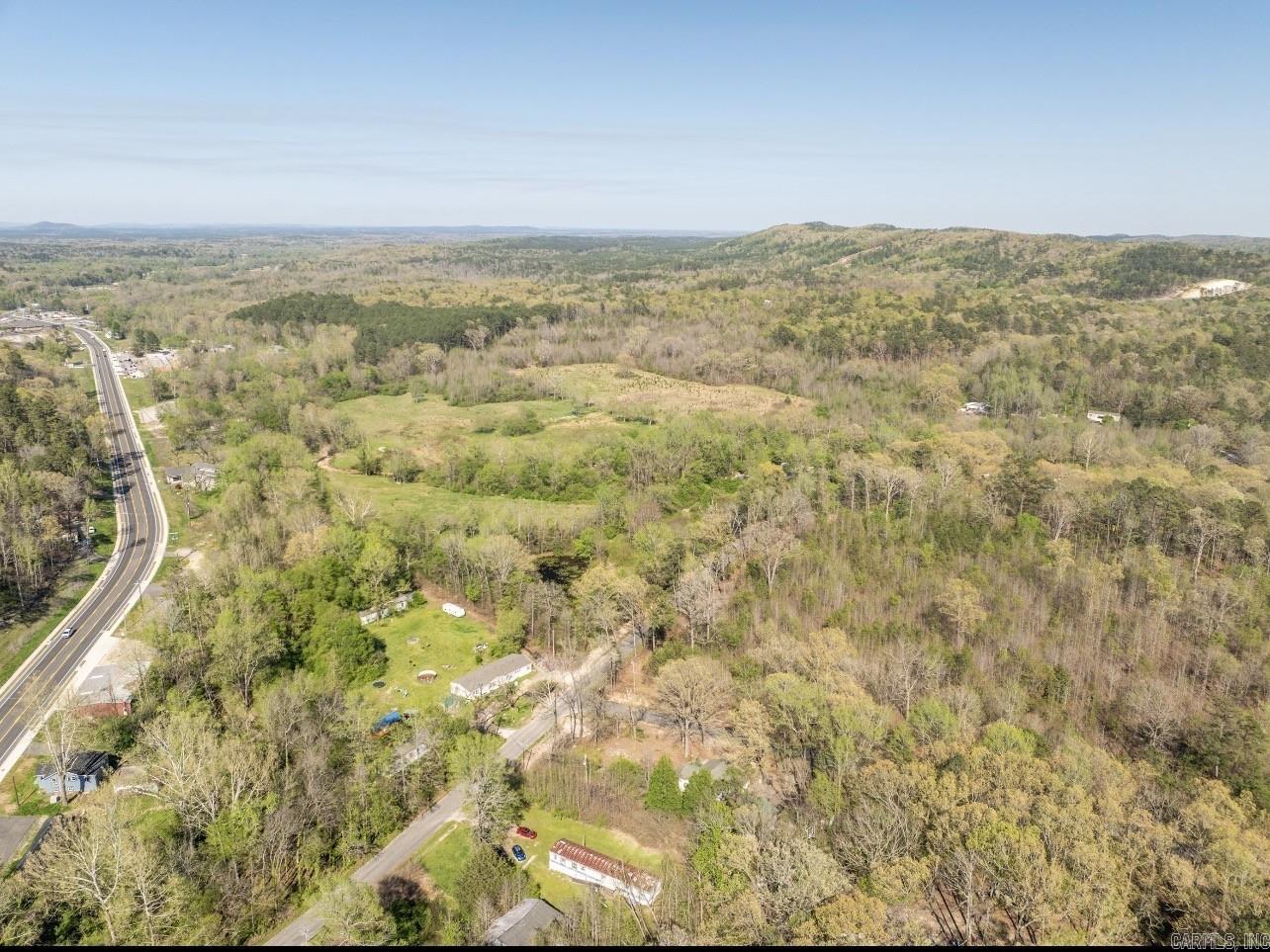 Beautiful 15.12 acre level creekside property with a spring-fed pond, ideal for your business, gentleman’s farm, or development. Conveniently situated just off Park Avenue, only a mile from the new bypass and Fountain Lake Schools. The property includes four mobile homes, which are assigned no value but will transfer with the land at closing; seller holds no title to the mobile homes. Current parcel lines on tax records are incorrect—see listing photos for accurate boundaries.