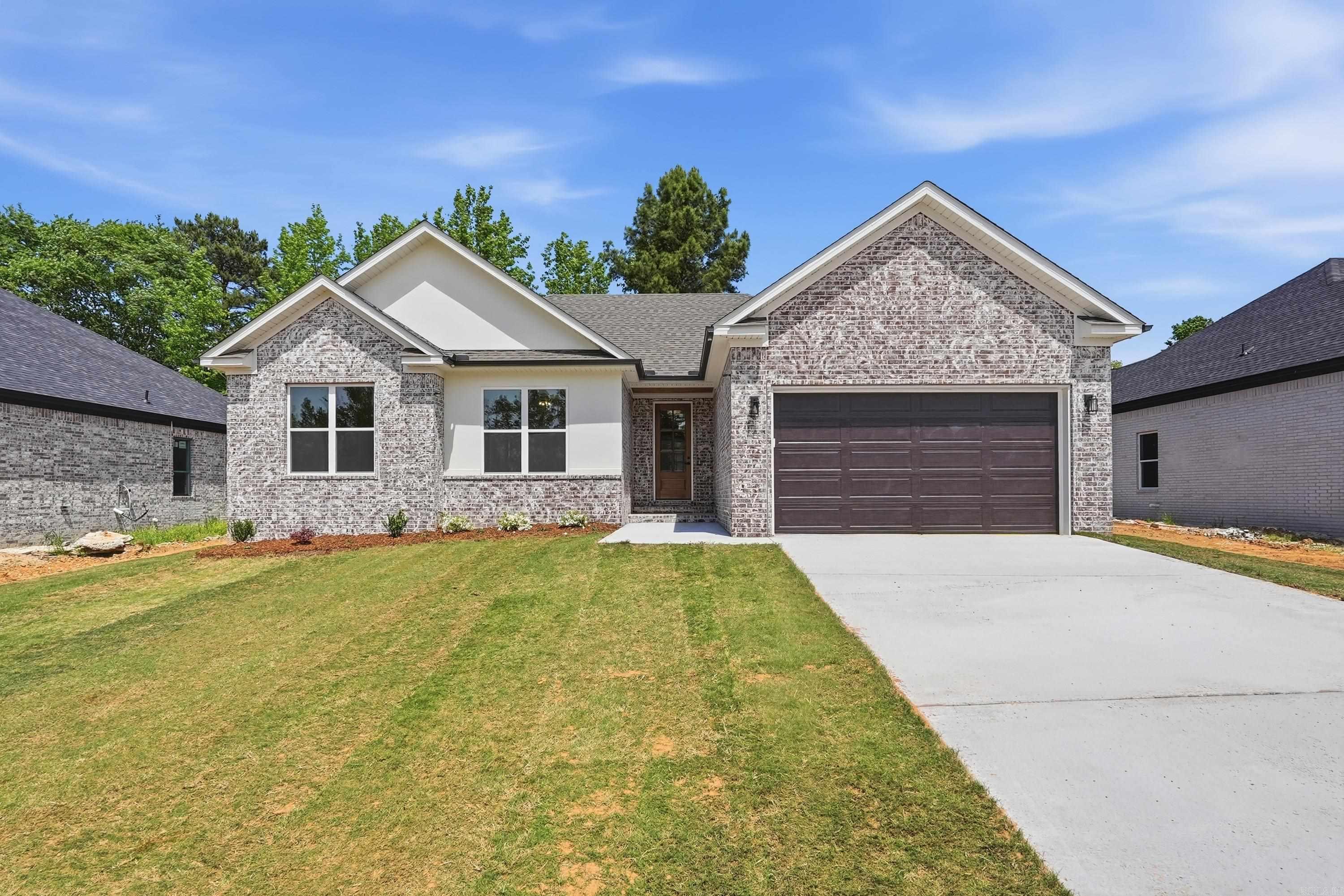 Beautiful new construction in Vilonia featuring 3 bedrooms and 2 bathrooms! The living room showcases tall vaulted ceilings and an electric fireplace, creating an inviting open space. The kitchen offers a great-sized pantry and is complemented by beautiful light fixtures throughout the home. The primary suite includes a tiled walk-in shower, soaking tub, and a spacious closet that conveniently connects to the laundry room. Enjoy outdoor living on the covered back porch. Taxes TBD.