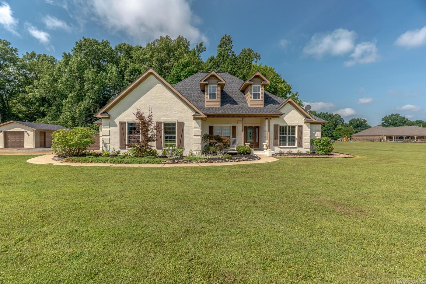Welcome to Market 3607 E. Thomas Green Rd. in Jonesboro, AR within the Nettleton School District. Situated on 3.34 +/- acres is a 2009 all-brick home offering 2,617 sf of well laid out living space. Wrapped in brick, topped w/ 2022 roof and accented by a covered front porch, mature landscaping, tree-lined views, private drive, 2-car garage, covered patio/deck w/ pergola, bonfire pit, wood privacy fence, raised garden beds, 2020 HVAC system and a heated/cooled finished 16x24 shop w/ lean-to and overhead doors. The open & split floor plan holds 4 bedrooms, 2.5 baths, office, formal dining, breakfast area, spacious living room w/ electric log fireplace, and built-ins. The kitchen features granite countertops, island, breakfast bar, stainless appliances, wall oven, walk-in pantry, wine cooler, and ample cabinet space. The primary suite offers a bay window sitting area, dual vanities, jetted tub, walk-in shower, and 2 walk-in closets. The guest bath includes a shower/tub combo. Conveniently located just minutes from town while offering the privacy of country living. Call today to schedule your tour and make this house your home.