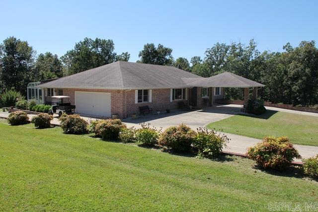 Beautiful & Spacious Brick home close to Lake access. Situated nicely on 1.3 acres this home features a vaulted ceiling and custom oak cabinetry throughout. Home built in 2007 with a fabulous sun room, Jacuzzi tub, and sound system! Partially finished walk out basement has half bath, workshop, boat storage, and large family room. Has potential to be a two family home with a few improvements! Fenced garden area, seasonal lake view on rear of property, extra detached 2 car garage & loads of storage space.
