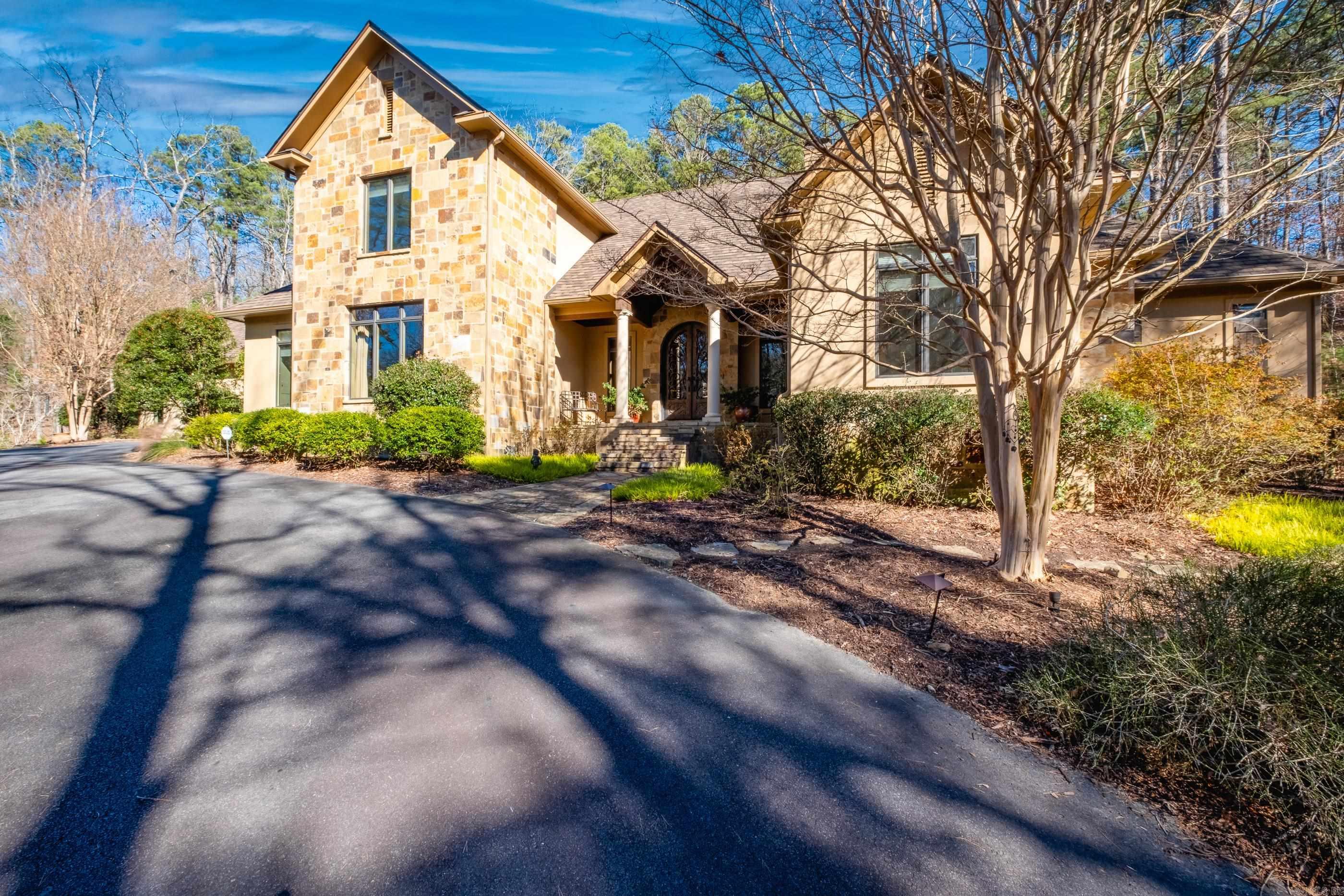 Luxurious yet warmly inviting, this elegant home blends timeless design with rich rustic character and exceptional craftsmanship. An impressive entry with custom doors opens to a stunning great room with soaring wood beamed ceilings, a massive stone fireplace, and beautiful heart pine flooring thru-out the main living areas. French doors extend the living space to a screened outdoor retreat. The kitchen is both beautiful and functional, offering honed and polished granite countertops, a generous center island, and seamless flow to a cozy hearth room with casual dining and a gracious formal dining space. Remarkable custom woodwork throughout the home adds warmth, depth and timeless appeal. The primary suite is a private sanctuary with an incredible spa like bath that must be seen to be appreciated and generous closet space. The main level also includes a guest en-suite, private office, and a well designed laundry room with built in desk and shelving. Upstairs offers two additional en-suite bedrooms, a large bonus or game room, and a separate sitting area. Set on 5 beautifully landscaped acres with mature trees, a tranquil waterfall, three car garage and abundant storage. Come see!