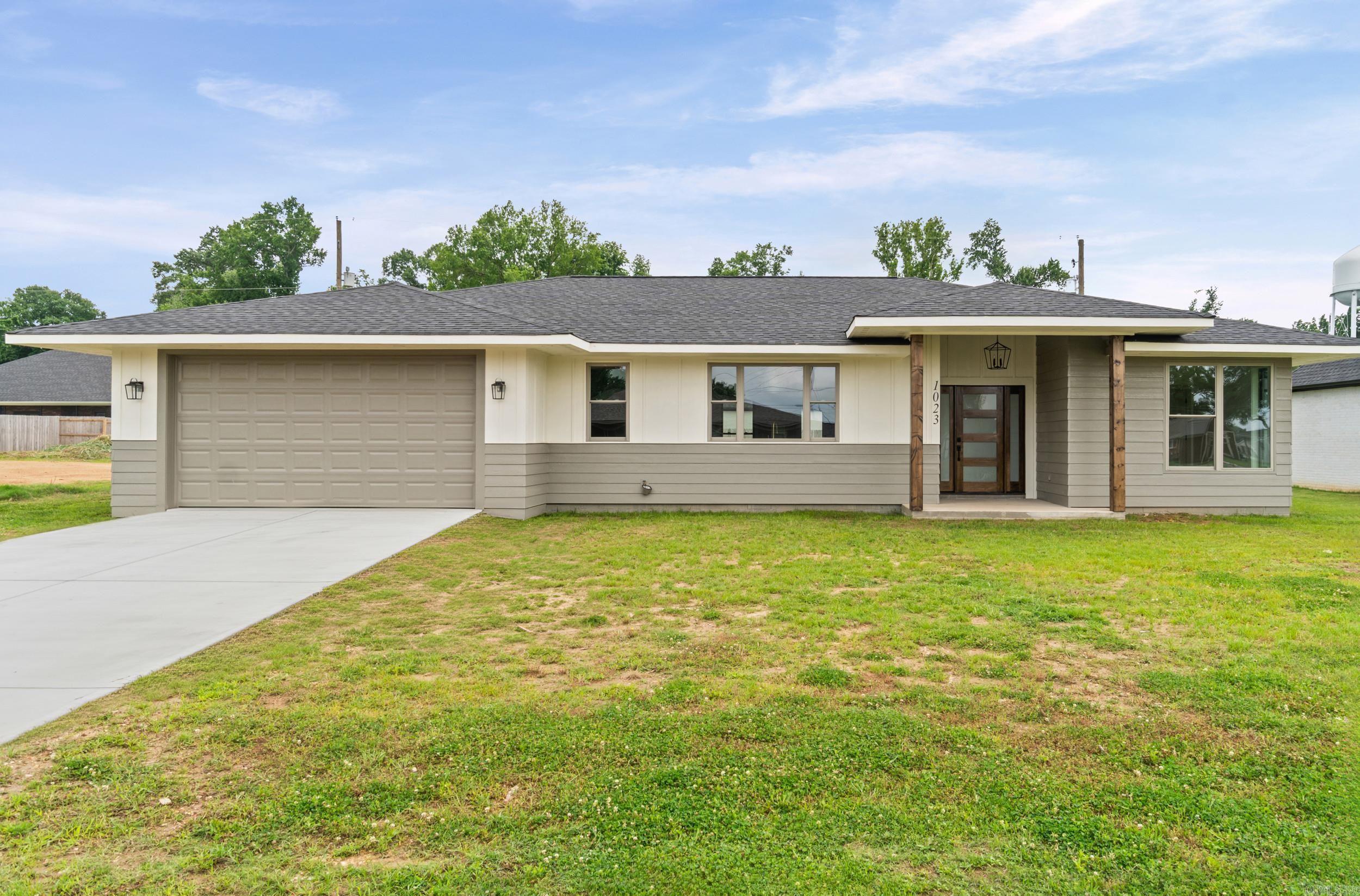 Brand new construction in the heart of Wynne! This super cute mid-century style home is move-in ready and thoughtfully designed with spacious rooms, high ceilings, custom lighting, beautiful millwork, and stylish tile selections throughout. The open floor plan features a stunning, light-filled kitchen with quartz countertops, ample cabinetry, quality appliances, a chic backsplash, and a walk-in pantry with additional storage.  The private primary suite offers a large bedroom, walk-in closet, and a gorgeous ensuite bath with double vanity, separate water closet, and a spacious walk-in shower finished in timeless tile. On the opposite side of the home, you’ll find two guest bedrooms and a beautifully finished guest bath.  Additional features include a garage, covered back porch, low-maintenance finishes, and a spacious backyard near schools and local conveniences. So much to love at this price point!