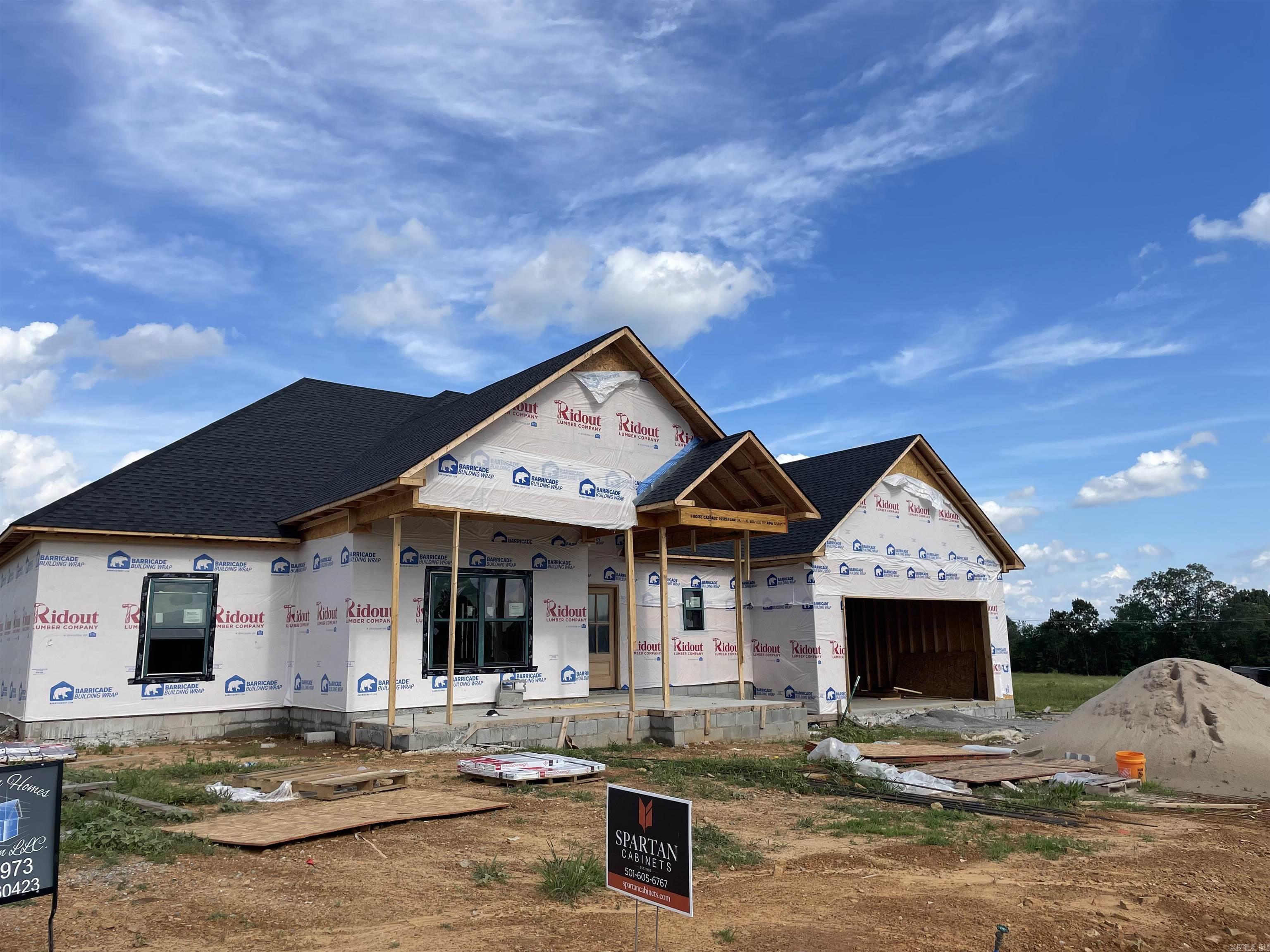 This under construction home in Searcy's Belmont Estates is ready for a buyer. Work with the builder to choose your finishes now in this 2,400 sq ft, 4 bed, 2.5 bath brick home. Great room will feature high ceilings, luxury vinyl plank flooring and an electric fireplace centered between two windows overlooking your back patio. The kitchen will include an oversized island, coveted hidden pantry and tons of cabinet space. Master bath will have a large soaker tub, custom tiled shower with body spray fixtures, split his and hers vanities along with access to the master closet and laundry room! Close proximity to the Country Club area and West Side of town makes this a perfect location. Additional photos are of similar completed home to show possible finishes. Estimated completion-mid to late September.