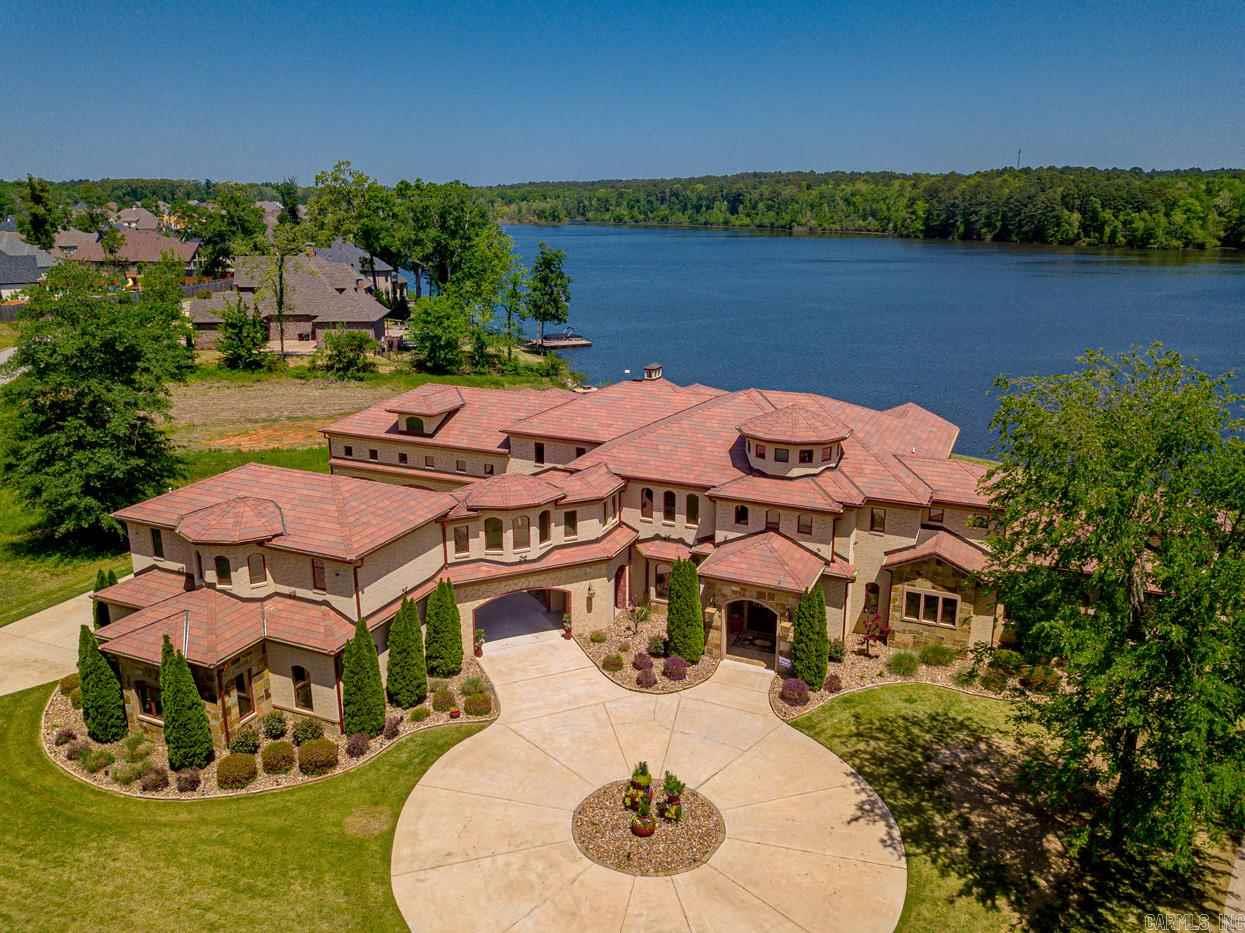 This stunning home sits on an acre on the water with breathtaking views Amenities include gourmet kitchen,theatre room with bar area,retractable doors,infinity pool, outdoor kitchen,large fireplace,fire pit,sea wall, boat dock. solid wood 8'stained doors, Full home automation package,geothermal heating and cooling, heated floors,Sauna,workout room, steam shower, stucco finish over brick,in-law quart. elevator shaft, bball court,foam insulation,office with half bath,too many amenities to list!
