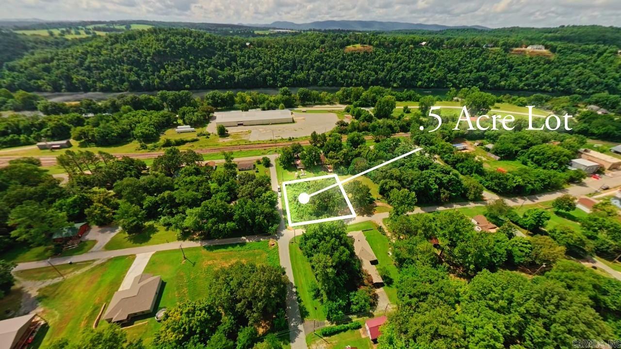 Prime Building Lot Near the White River | Cotter, Arkansas Discover the perfect place to build in the heart of the Arkansas Ozarks with this beautiful 0.50± acre lot in the desirable Cotter Lots Subdivision. Featuring gently rolling terrain accented by a few mature trees, this property offers an excellent setting for your dream home, vacation retreat, or investment property. Electric and city sewer are available at the road, making the building process even more convenient.  Located just one block from the legendary White River, you'll enjoy quick access to world-class trout fishing, boating, kayaking, and endless outdoor recreation. The charming town of Cotter is known as the "Trout Capital of the USA" and offers a welcoming small-town atmosphere while remaining close to shopping, dining, and medical facilities in nearby Mountain Home.  Whether you're looking to build now or invest for the future, this affordable lot combines a desirable location, available utilities, and exceptional access to one of North Central Arkansas' most sought-after river communities. Don't miss your opportunity to own a piece of the Ozarks just steps from the White River.
