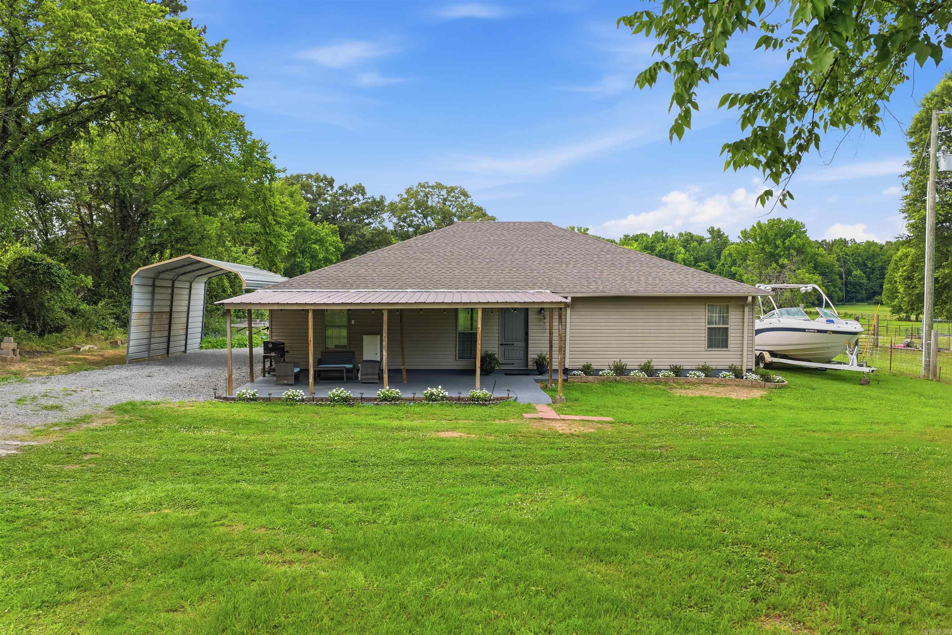 Enjoy your morning coffee on the amazing covered front porch while taking in the picturesque views of the nearly one-acre property with fruit trees. Take a shower/bath in the Jet tub in master with two shower heads. Cook for your family in this large kitchen! The home also offers covered parking, plenty of outdoor space, and a brand-new roof for added peace of mind. Whether you’re looking for room to spread out, enjoy the outdoors, or entertain family and friends, this property combines comfort, functionality, and scenic surroundings in one exceptional package. Don’t miss this opportunity to own your own slice of paradise!