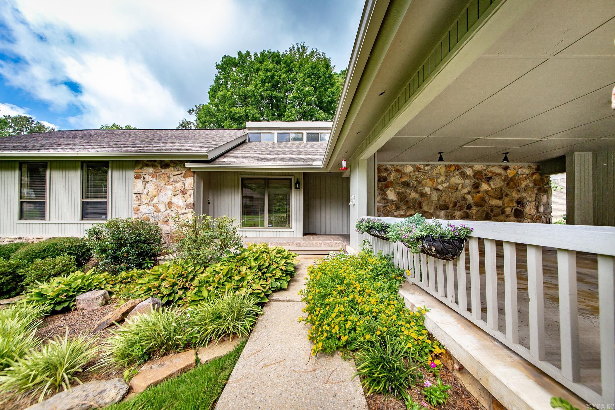 Lake Access to Greers Ferry Lake.  Walk out the back door and walk down the driveway to the lake and cool off. The water is clear and refreshing. New roof in 25, new heating and air 25. Open and airy floorplan.Mostly hardwood flooring. Kitchen offers butlers pantry, Corian countertops,  solid wood cabinets. Tall slanted ceiling in primary bedroom with lots of natural light,has office with exterior door going onto the back deck. Walk-in closet. Separate den with fireplace. Living has fireplace too.This home is great for entertaining family and friends. Some pics are AI generated. This property is located in a very nice neighborhood and is just 5-10 minutes from Little Red River.  Fish beautiful Greers Ferry Lake or the Little Red River.  What's your preference? Frank Lloyd Wright design.