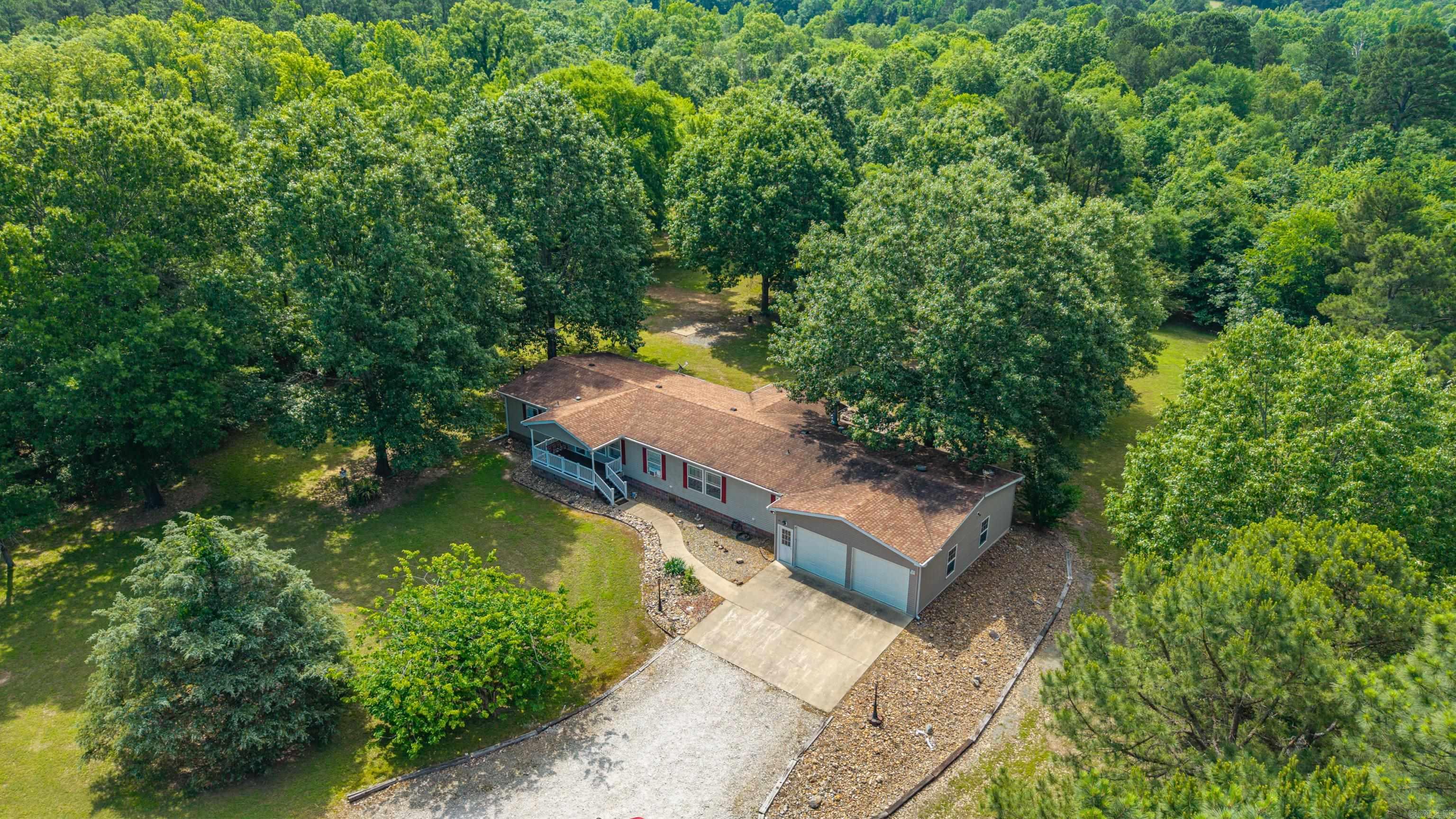 Spacious Serenity Awaits You! Discover your dream home nestled on 4.35 stunning acres of picturesque beauty. This 3-bedroom, 2-bathroom residence modular home boasts a generous 2,280 square feet of living space thoughtfully designed for comfort. Whether you're hosting guests or enjoying quiet evenings, this home's layout accommodates it all. Key Features Include Great Room Perfect for entertaining or relaxing with loved ones. Separate Den* Ideal for working from home or creating a cozy retreat. Eat-in Kitchen with a Breakfast Nook A versatile culinary space designed for casual dining and family meals. Front Porch & Back Deck Enjoy morning coffee or unwind while taking in the tranquil views. For the Outdoors Enthusiast. Oversized Attached 2-Car Garage Perfect for storage, workshop space, or housing your tractor/mower. RV Space with Utilities Ready for adventure lovers and visiting guest. Unbeatable Location Conveniently located near town, offering easy access to businesses and day-to-day necessities while maintain a sense of serenity and privacy. This home is the perfect blend of comfort, convenience, and countryside charm.