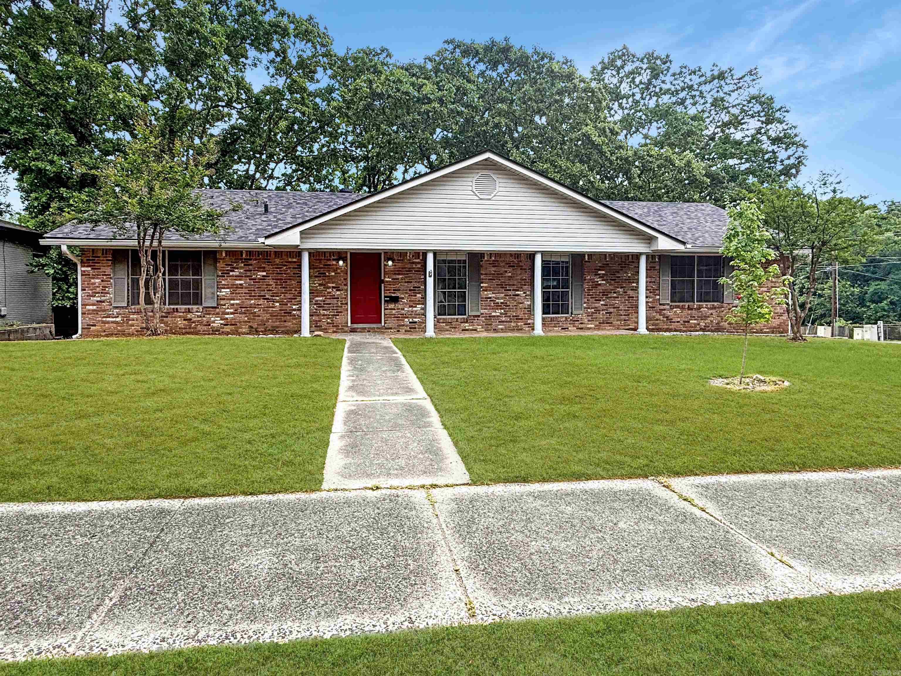 Welcome to this charming home in the highly sought-after Lakewood Subdivision! This 3 bedroom 2 bath home sits proudly on a desirable corner lot and offers comfort and convenience in one of North Little Rock's most established communities. Interior includes hardwood floors, new backsplash in kitchen, spacious utility room, new paint. Exterior has large back yard with shop/storage, beautiful trees, and only five minutes from The Old Mill one of Arkansas historic re-creations and most recognizable landmarks that even appeared in Gone With the Wind! You'll enjoy easy walk to one of the area's most beloved landmarks and scenic spots as well as trails to walk around the lake.   Residents of Lakewood community enjoy access to fantastic neighborhood amenities including a pool, tennis courts, and playground. This home is perfectly priced at $215,000, making it an excellent opportunity for investors or first time home buyers. Don't miss out on this amazing opportunity today! Agents see remarks. Some photos are AI enhanced, appearance may vary.