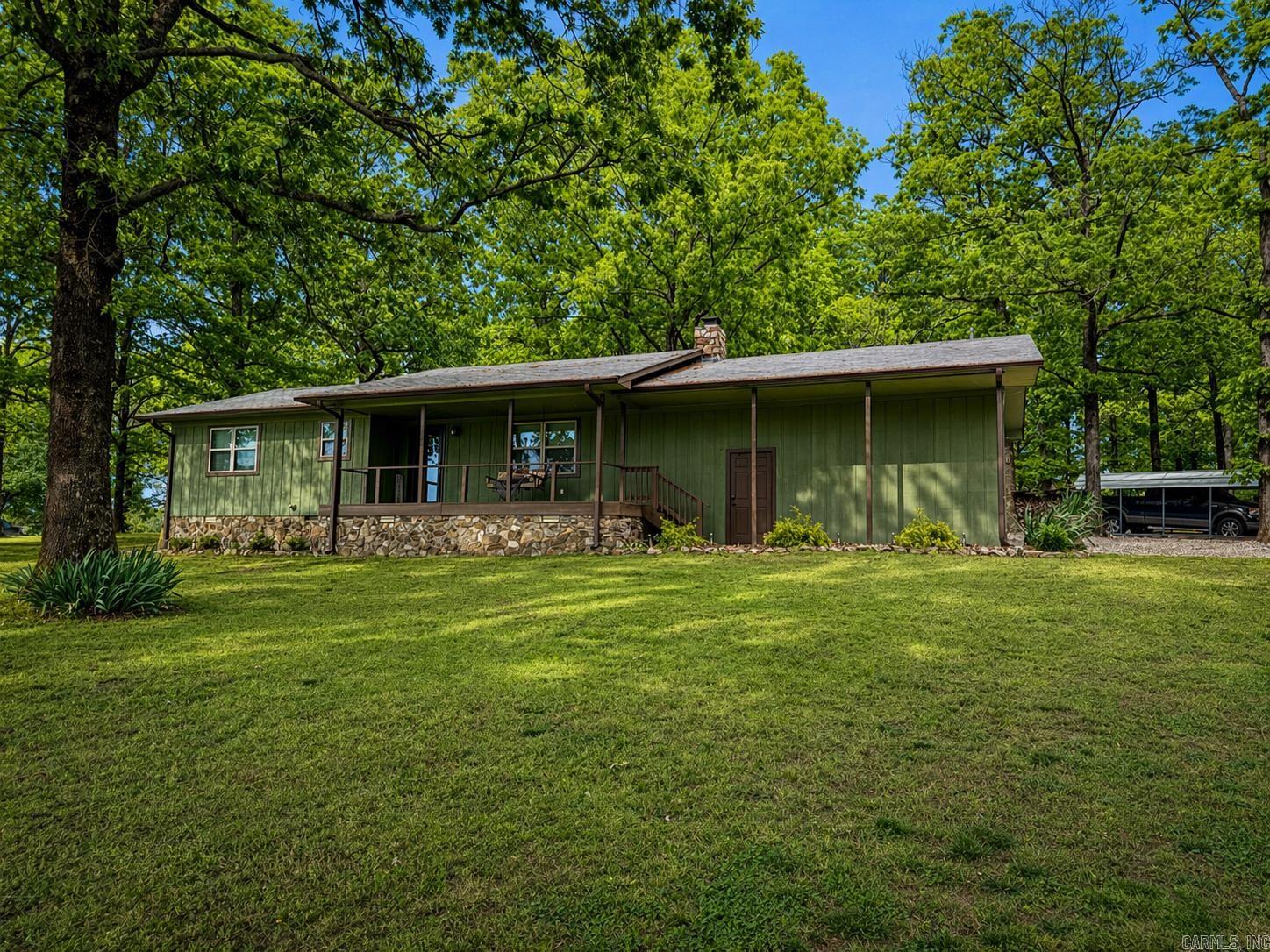If you’ve been waiting for a place that feels like your own private Arkansas retreat, you just found it. Tucked into a pine-lined, park-like setting, this gorgeously remodeled home sits like a hidden basecamp, complete with a private pond for fishing, quiet evenings under the stars, and deer that don’t just wander through, they pour out of the timber. Inside, the remodel is the kind you don’t see every day, clean, high-end, and truly move-in ready. The primary suite is next-level: two bedrooms were combined to create an oversized retreat with a huge walk-in closet and a gigantic bathroom that feels like a private spa. Every space flows with comfort and intention, making this home feel equal parts stylish and livable. Outside is where the lifestyle really shows up: multiple outbuildings give you room for tools, toys, projects, and hunting/fishing gear. There’s even a converted conex container set up for secure storage/workshop use, perfect for the person who needs real utility, not just “a shed." This is the kind of property that lets you live the way you’ve talked about living: cast a line in your own pond, watch wildlife from your own yard, and keep adventure within easy reach!