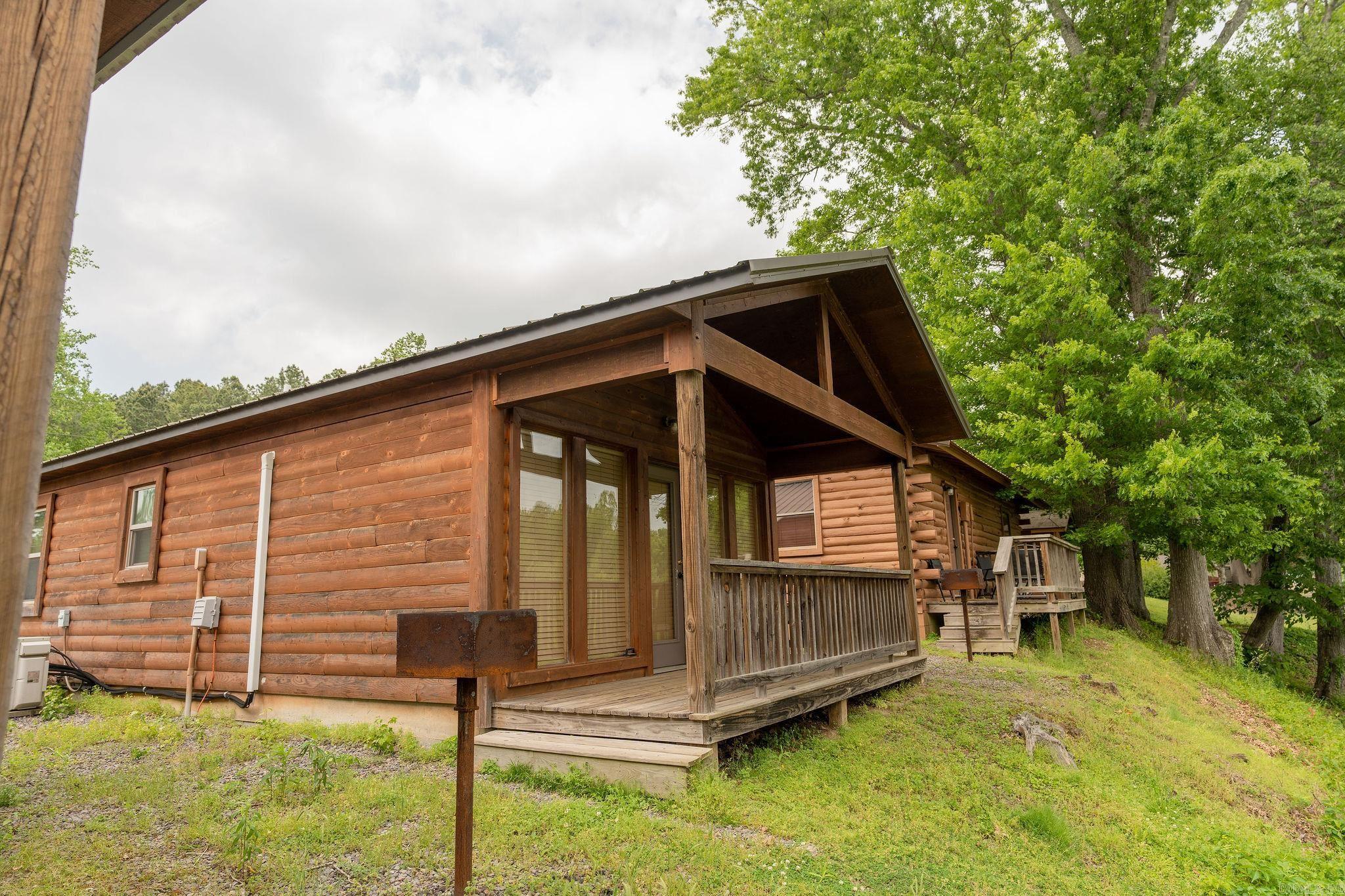 Discover Cabin 3E a riverside luxury and investment property on the pristine Little Red River at Swinging Bridge/Winkley Shoals. This fully furnished, low maintenance with metal roof and concrete floors, turn-key cabin that offers direct access to a wadeable fishing shoal and also includes a private boat slip at the dock—perfect for anglers seeking world-class fishing right at their doorstep when the water is high or low. Nature enthusiasts will be captivated by the abundant wildlife: watch geese, turkeys, blue herons, diversity of ducks, woodpeckers, and rare sightings of trumpeter swans and painted buntings from your serene retreat. Nestled in a tranquil, natural setting, this charming cabin blends rustic appeal with modern convenience, boasting strong income potential for savvy buyers. Enjoy the cool river waters and the convenience of multiple restaurants just a short stroll away. Greers Ferry Lake is less than 7-8 minutes away so plan your vacation accordingly!! Call today to schedule your exclusive showing and secure this exceptional opportunity!