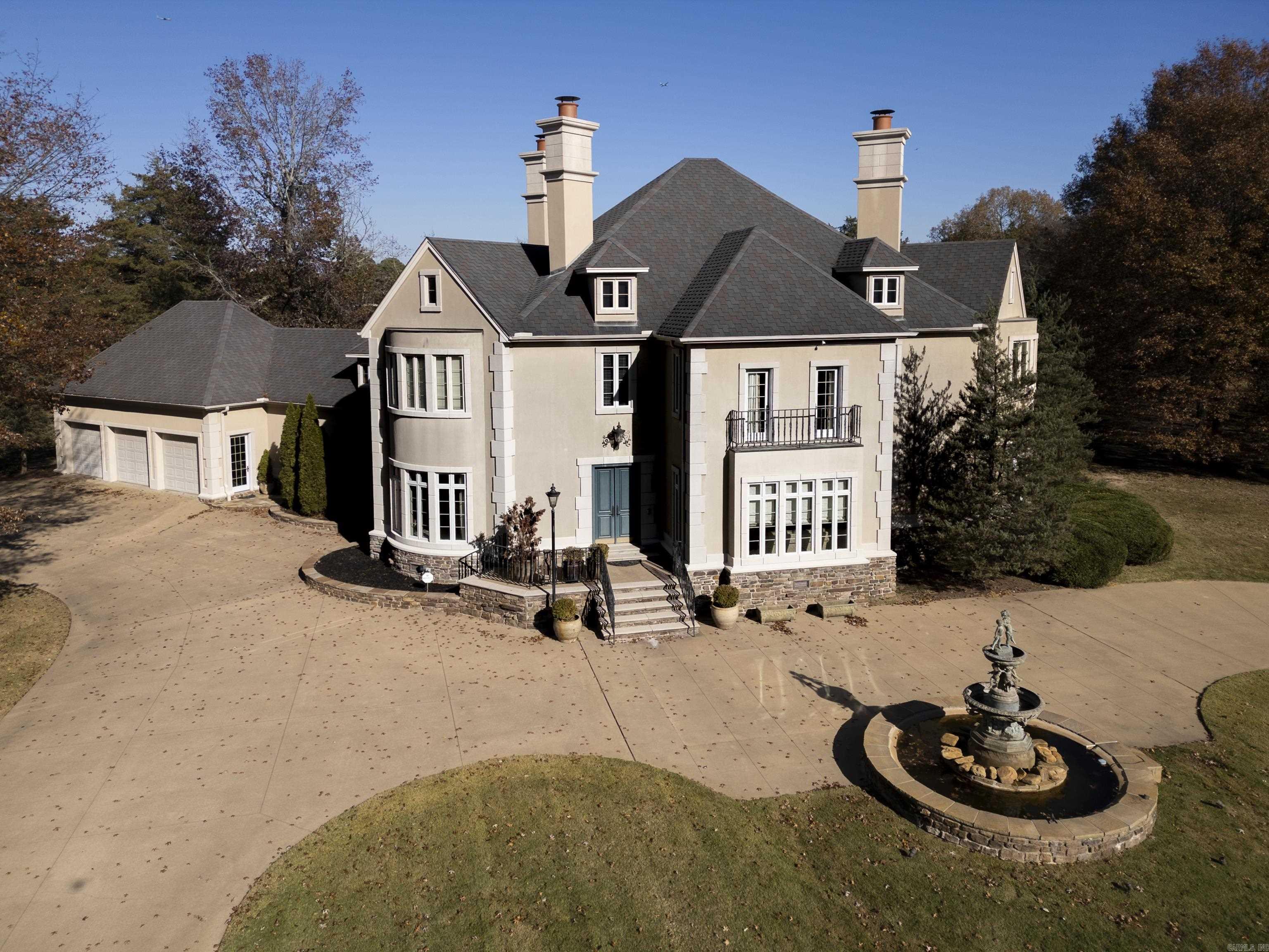 Step into a world of timeless elegance in this 5,402 square foot Searcy estate. The grand entrance, adorned with marble columns and a stunning fireplace, sets the tone for the luxurious interior. The kitchen is a culinary enthusiast's dream, featuring Jenn-Aire built-in appliances that combine functionality with sleek design. These appliances ensure that every meal preparation is an effortless experience. Complementing the main kitchen area is a butler's pantry, providing additional storage and workspace. The living room exudes elegance with its European-imported mantle. This exquisite piece pairs beautifully with the ornate fireplace. In the living room and foyer, the ceilings soar to an impressive height of 20 feet. Throughout the rest of the house, the ceilings maintain a more standard height of 10 feet. One of the standout features of this home is the inclusion of ceiling frescoes in the great room and formal dining room. This exquisite home, perfectly situated just off the 7th tee of the Searcy Country Club. The fountain was also imported from Europe. There is an in-ground pool. Check out the attached narrative for more information! Agents, please see remarks.