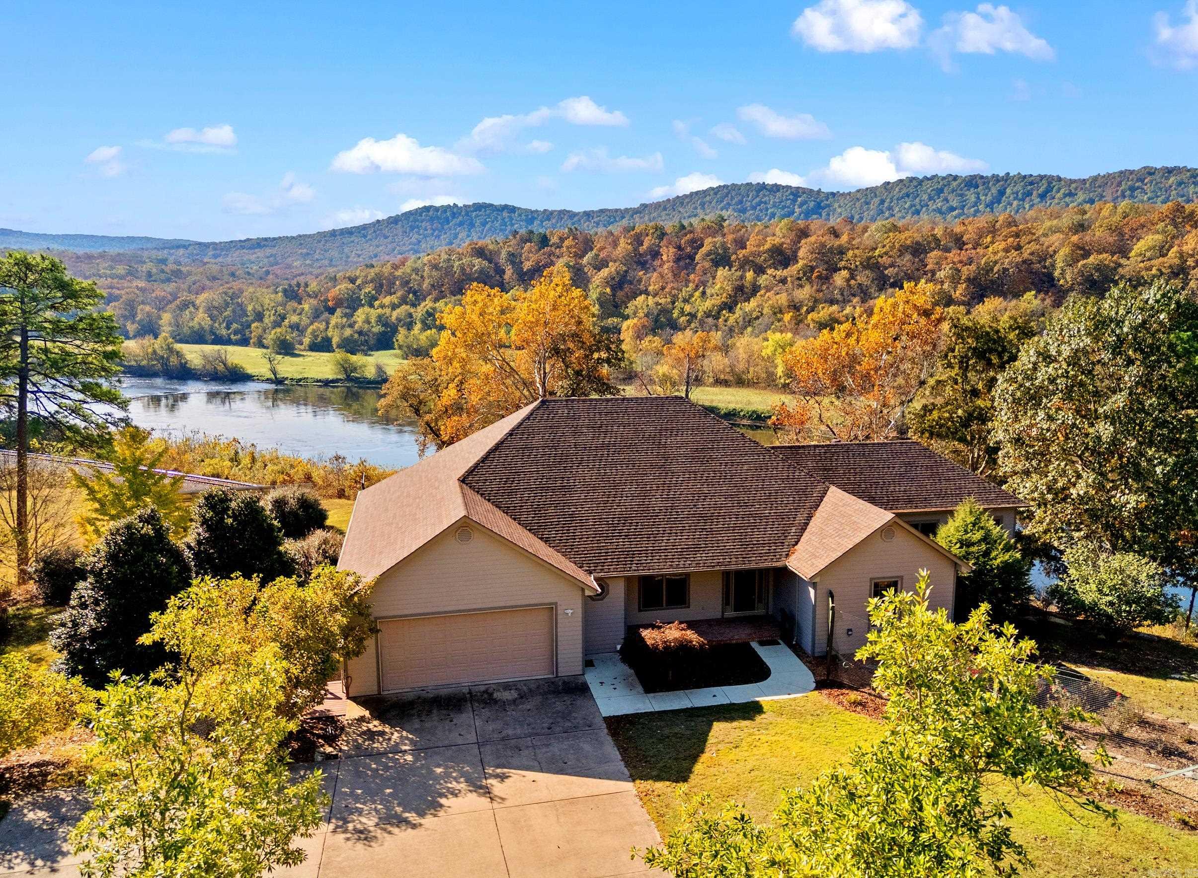 Experience peaceful living along the White River. This stunning 3 bed/2 bath home offers river views from the kitchen, dining room, primary suite, and sunroom. Inside enjoy gas fireplace, granite countertops, hardwood floors, and elegant crown molding. Relax in your in-home pool while taking in nature's beauty. Energy-efficient solar panels and a home generator provide peace of mind. The 11+ acres features 2 ponds and a 3-bay shop. The garden suite on the lower level includes a deck with river views, sitting area, bedroom, and bathroom with private entrance, perfect for guests. This home is located in a sprawling subdivision which includes access to a private clubhouse and boat ramps.