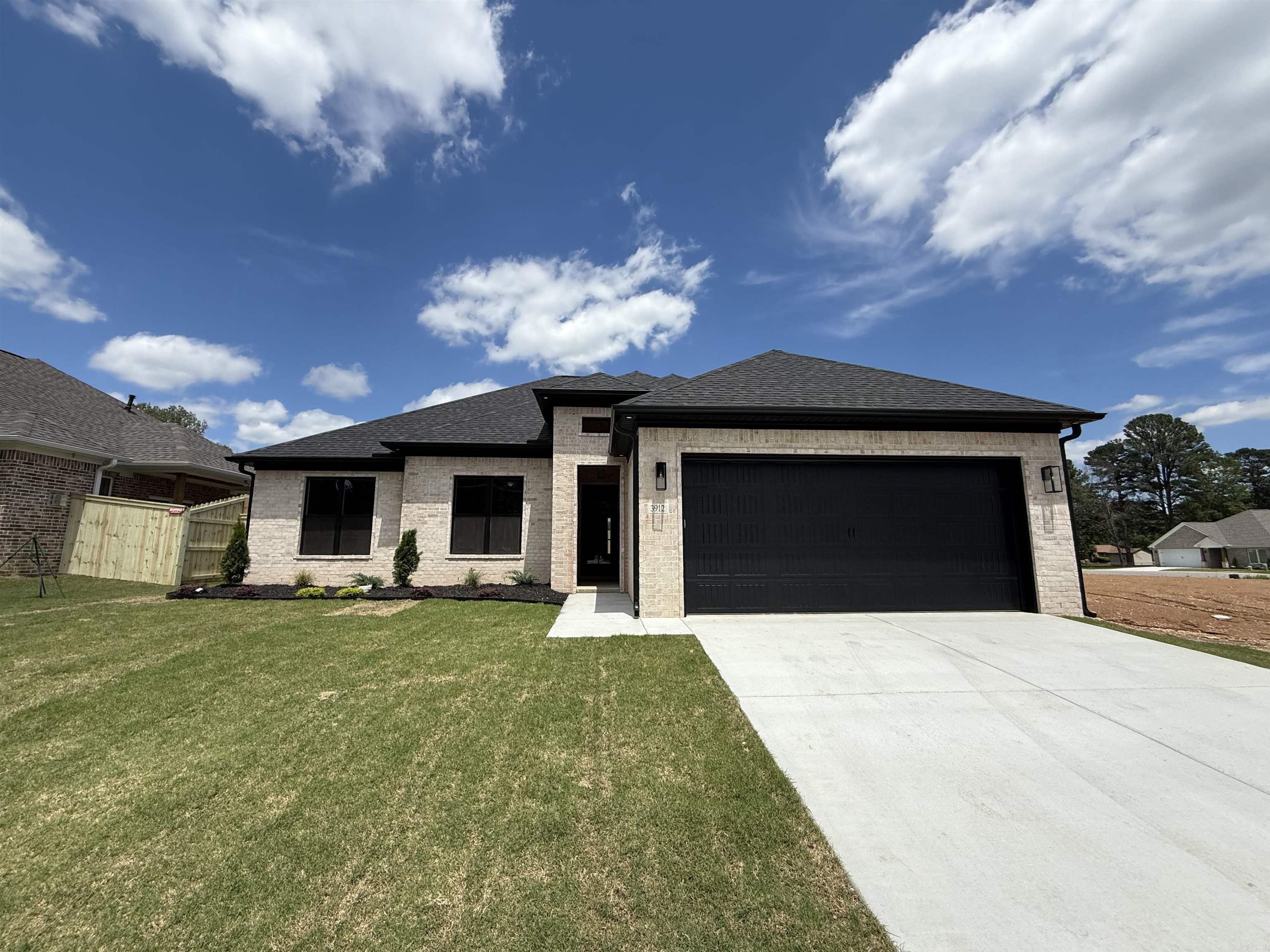 Welcome to your dream home in Benton’s premier subdivision, Spencer Crossing! This stunning brand new construction boasts a spacious split floor plan designed for modern living. Step into the heart of the home where custom-built, soft-close floor-to-ceiling cabinets adorn the kitchen, complemented by a freestanding stove & a convenient pantry for all your culinary needs. Cozy up by the brick gas fireplace in the open living area, perfect for entertaining or relaxing evenings at home. Retreat to the private primary suite featuring a luxurious primary bath complete with double vanities, soaker tub, and a large walk-in tile shower, offering a spa-like oasis right at home. The split floor plan ensures privacy with spacious spare bedrooms, providing ample space for family or guests. Step outside onto the covered porch & immerse yourself in the tranquility of the backyard, where you’ll love spending time in the expansive outdoor living space. Whether it’s morning coffee or evening gatherings, this home offers the perfect setting for enjoying the outdoors. Don’t miss out on the opportunity to make this beautiful home yours!