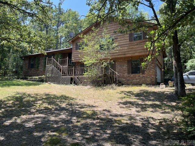 A little bit of heaven on 10 AC close to Conway and easy commute to Little Rock in sought after Pine Village Estates.  The home is back from the paved road that wonders through the property and is very private. Wet weather creek.  Mostly wooded. The home needs some work and is to be SOLD "AS IS".  Beautiful hardwood floors, split level, eat in kitchen, large primary bedroom and bath separate from the 3 bedrooms and bath at the other end of the home. Washer/Dryer/Frig to convey.  Buck Wood burning fireplace in a huge family room. Lots of light in the eat in kitchen with an island. There is a small shop room in the oversized garage.  Moisture barrier in the crawl space.  Swimming Pool needs new liner and equipment plus the front and back decks need work.  HVAC 2017, Architectural Roof apx 10 years old.  This property is located on the last road on the mountain and dead ends at a cul de sac.  You can't get any more private than that!  AGENTS SEE IMPORTANT information in the remarks and docs!