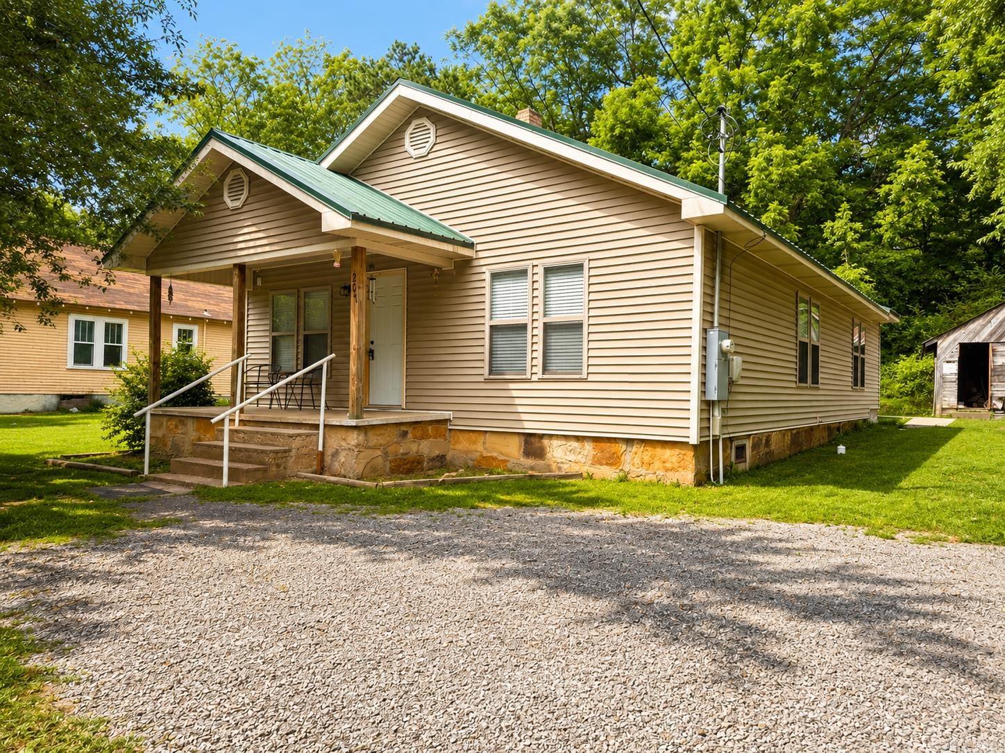 Move-in ready and freshly remodeled, this in-town charmer sits on a surveyed 0.16-acre lot and blends low-maintenance living with modern comfort. A durable metal roof and clean vinyl siding mean easy upkeep year-round, while the updated interior offers an inviting, open feel.  Inside, you’ll find 3 comfortable bedrooms and 2 full bathrooms, a bright living area, and an efficient kitchen with ample cabinet space. A dedicated laundry area adds everyday convenience. The floor plan is flexible—ideal for a primary residence, investment property, or nightly rental.  Outdoor space includes a manageable yard with room for a garden, or pets. With its central location, recent updates, and practical features, this property is a versatile opportunity with strong appeal for owners and guests alike.