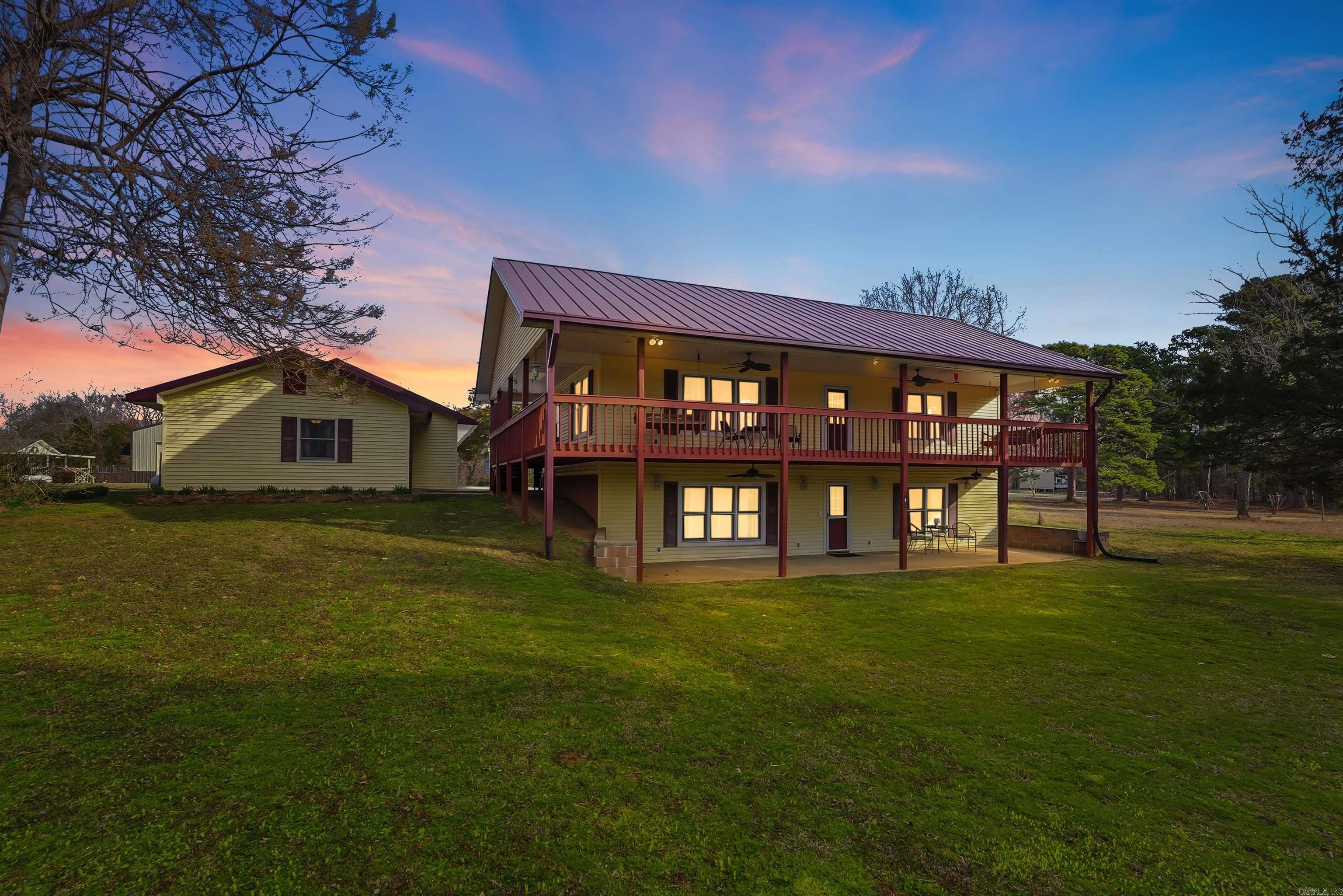 Two-Story Home with separate Guest Apartment.  This property is located around the corner from Shiloh Marina and Shiloh Park.  The Guest Apartment (42 x 24) has full kitchen, one bedroom, washer/dryer hookups, plus a full bath. The Property also has a NEW 3-car metal building (28 x 45).  The home has kitchen, Master bedroom and bathroom on the main level, W/a wraparound porch.  Downstairs also has its own living room/game room, plus 2 more bedrooms, and a full bathroom. You can walkout of the basement onto a covered patio that runs the length of the home.  With the apartment this home is set up to host large families.  It can also give you extra rental income.