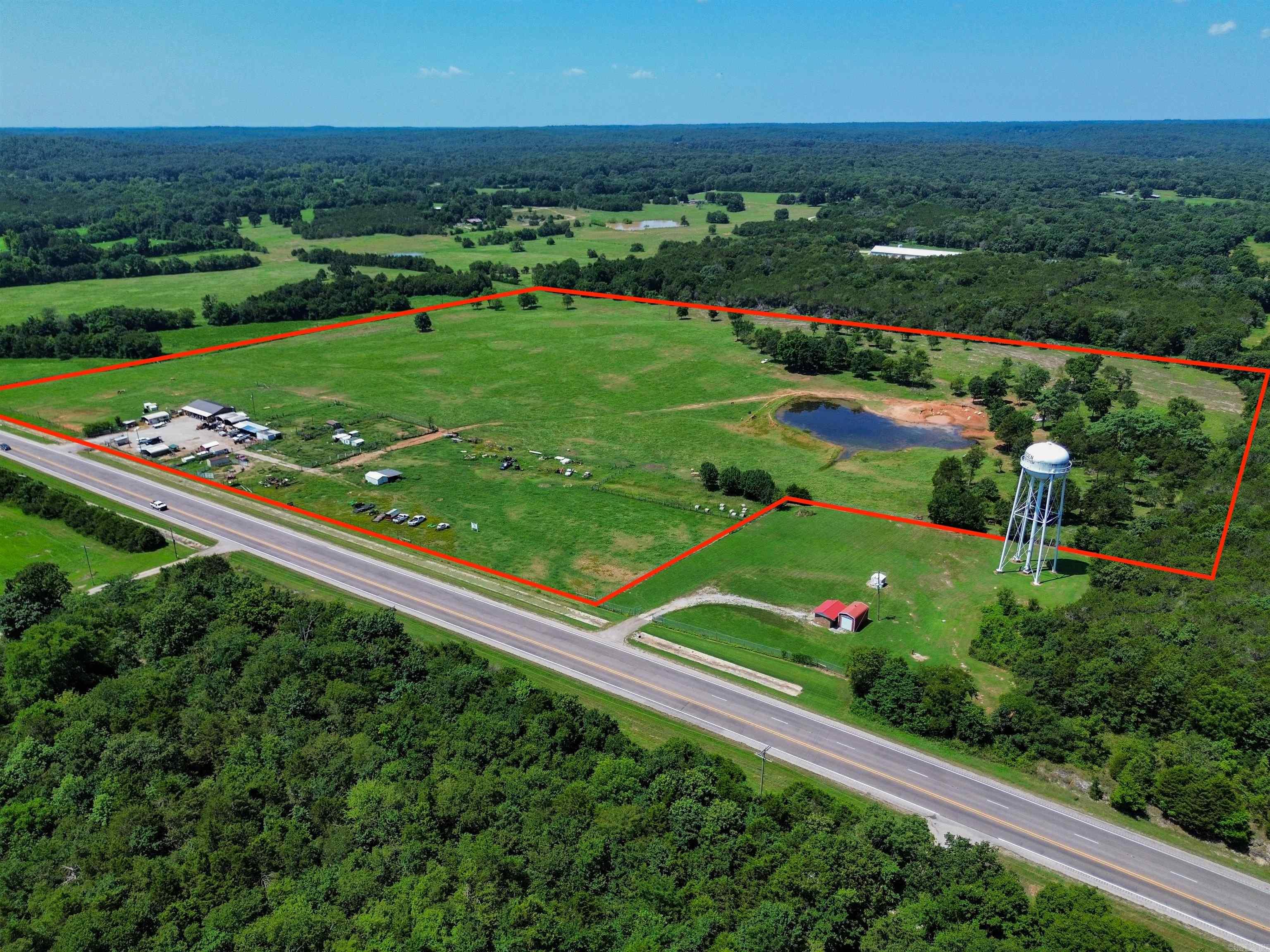 Located just one mile outside the Imboden city limits, this versatile 34.83-acre (±) property in Black Rock, Arkansas offers an ideal blend of peaceful country living and strong commercial potential. With over 1,100 feet of Highway 63 frontage, the opportunities are endless. The inviting 1,080 sq. ft. home features comfortable living space and a spacious covered front porch, perfect for relaxing or entertaining family and friends. Whether you’re looking for a place to call home or room to expand, this property is ready for your vision. Fully fenced and cross-fenced, the land is ideal for cattle or other livestock, offering lush pasture and a large pond. Multiple outbuildings provide ample storage and workspace, making it suitable for farming or business use. With its prime location and highway visibility, this property offers exceptional development potential for a farm, event venue, gas station, car lot, or retail site. Combining rural charm with excellent access, this is a rare opportunity. Schedule your private showing today! (Lot drawing pictured is approximate.)