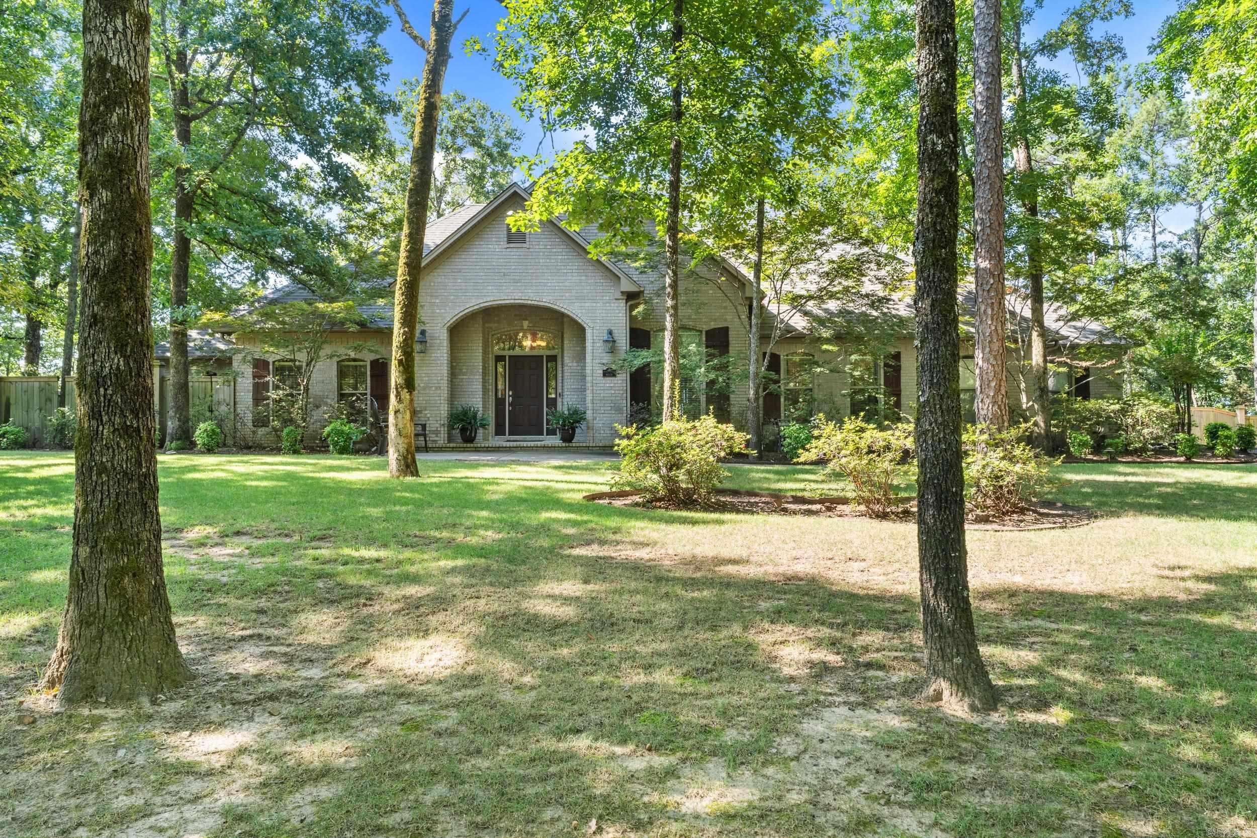 Wonderful Dogwood Estates property with 6 bedrooms, 4 1/2 baths, 3 living areas, nestled on 3.25 acres of scenic beauty in Conway! The beautiful living room with fireplace, formal dining room & sunroom create a warm, inviting atmosphere with abundant natural light & access to the outdoor living areas. The kitchen is a chef’s dream complete with stainless steel appliances, double ovens, gas range, and two expansive islands offering both function and flow for entertaining. This spacious home offers 5 generously sized bedrooms on the main level each w/large closets. The primary suite has tray ceiling, fireplace & large bathroom w/double sinks, walk-in shower & separate tub. 6th bedroom & full bath upstairs alongside a versatile bonus room with kitchenette/wet bar perfect for a media space, game room, or playroom.   Outside enjoy the spacious deck & screened-in porch offering breathtaking views of the surrounding area. The home also features a large three-car garage with a workshop area.