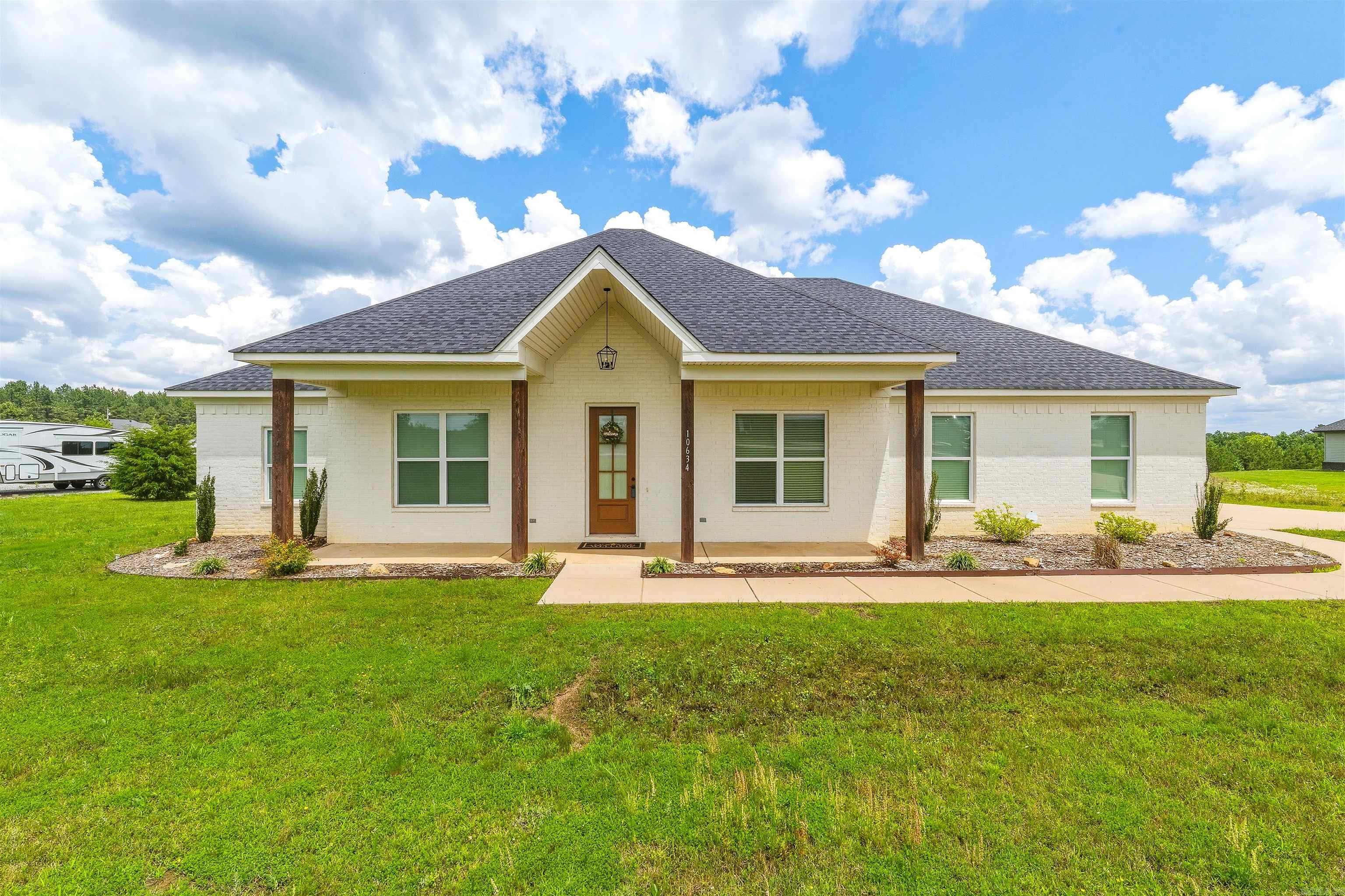 Practically newer build on 1.76 acres — where peaceful country living meets modern comfort. Situated on a scenic homesite with breathtaking views and frequent wildlife sightings, this beautifully crafted 4-bedroom, 2-bath home offers the perfect blend of warmth, style, and functionality. From the moment you step inside, you’ll appreciate the open-concept layout designed for both entertaining and everyday living. The spacious kitchen serves as the centerpiece of the home, featuring a large gathering island, sleek countertops, abundant cabinetry, and upgraded appliances. The inviting family room showcases soaring ceilings with stunning wood beams and a floor-to-ceiling rock wood-burning fireplace that creates a warm and welcoming atmosphere. The private primary suite is a true retreat with elegant beam accents, a spa-inspired bath with a large walk-in shower, and a spacious closet. Step outside onto the covered back porch and unwind while enjoying peaceful sunsets and views of deer roaming the property. With its thoughtful design, beautiful finishes, and serene setting, this home offers the best of country living while still providing modern conveniences. PLUS Qualifies for RD Loan.