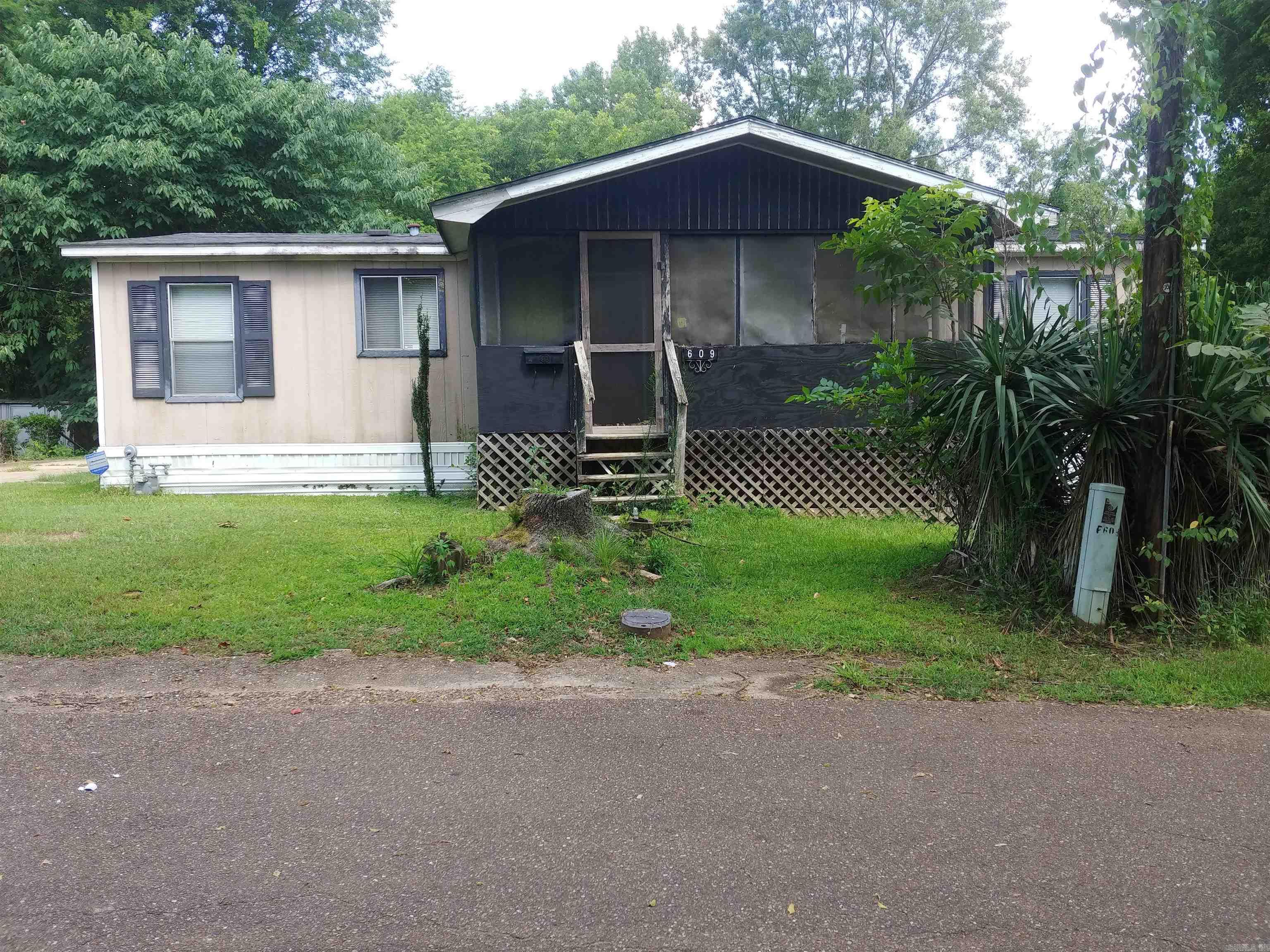This 3 bedroom, 3 bath manufactured home sits on a quiet lot tucked away in an older neighborhood.    The family room area has a gas fireplace and lots of space.  All bedrooms are nice size and there is a screened in porch off the family room.   The seller is willing to sell the contents of the property if interested.  The property is being sold "as is where is"  This is  a great starter home.