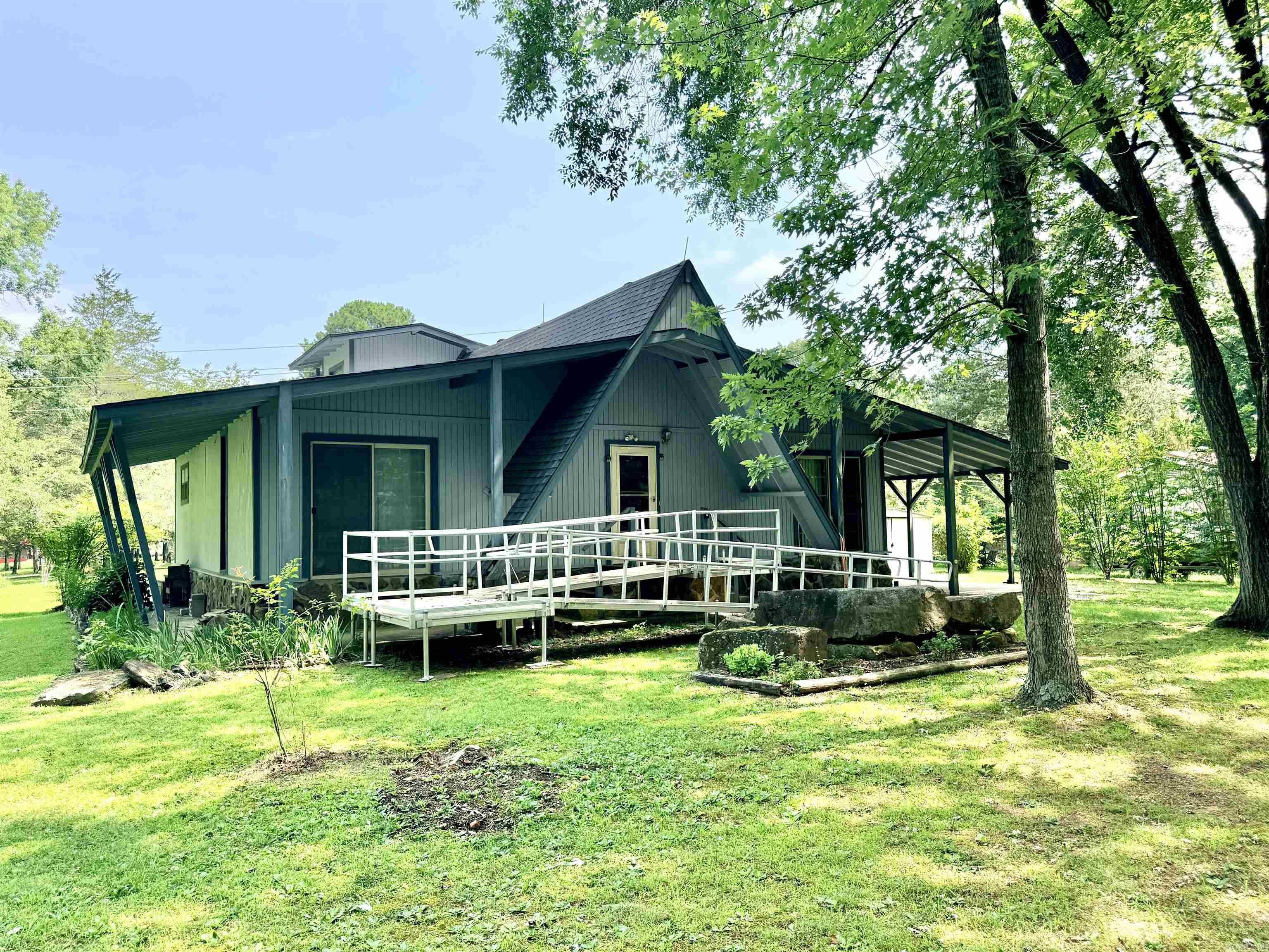 Take advantage of this great deal and have your own lake cottage getaway! This 2 bedroom, 2 bath A-frame style home has great potential for a weekend home or permanent residence! 1440 sq ft with 2 storage sheds, attached storage room and a "reading" loft with exterior access and balcony. DEVILS FORK PARK and access to beautiful GREERS FERRY LAKE within 1 mile! Beautiful shaded lot! Being sold As-Is.