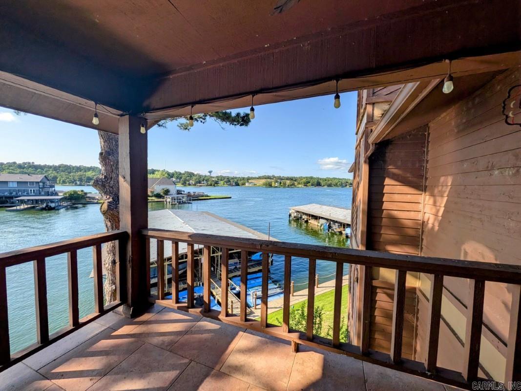 Escape the hustle and bustle of crowded weekend rentals and discover the tranquility of Lake Port, one of Lake Hamilton's exclusive, long-term-only gated communities.  Nestled within a well maintained lakeside complex, this charming Lake Port condo presents an exceptional opportunity to experience the best of relaxed lake living. The property boasts an array of desirable amenities, including a pool, lakeside boardwalk and beautifully landscaped grounds. Imagine starting your days with a cup of coffee or unwinding in the evenings, enjoying your surroundings from your private balcony. Furthermore, the property includes a covered boat stall with a lift, perfect for the boating enthusiast. This two-bedroom, two-bath condo seamlessly blends comfort and sophistication, offering the ideal setting for creating lasting memories. Embrace the opportunity to personalize this beautiful space and make it your own tranquil lakefront haven. With nightly rentals prohibited in Lake Port, residents can enjoy an unparalleled sense of peace and quiet. No wear and tear from rental traffic here. Long term rentals are allowed.