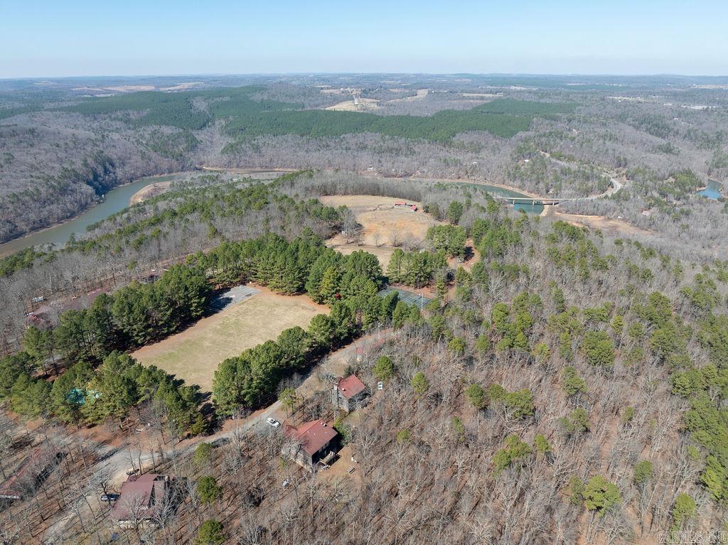 Camp Bear Track is a unique opportunity to purchase an established youth camp and retreat facility in north central Arkansas. Approx. 130 wooded acres with about 600 feet of Corps of Engineers lake frontage. Improvements include 25+ buildings, a 10,000 sq ft lodge with commercial kitchen and dining hall, cabins, offices, chapel, pool, sports fields, climbing tower, high ropes course, maintenance buildings, and extensive outdoor recreation areas. Designed for 125+ campers, the property is well suited for camp, retreat, ministry, educational, or outdoor program use. To be sold furnished with most equipment included, excluding personal items. Owners may remain available for a transition period. Rare turn-key investment opportunity.  Shown by appointment only. No exceptions. ABSOLUTELY NO TRESPASSING - DO NOT enter the property without a licensed agent present.