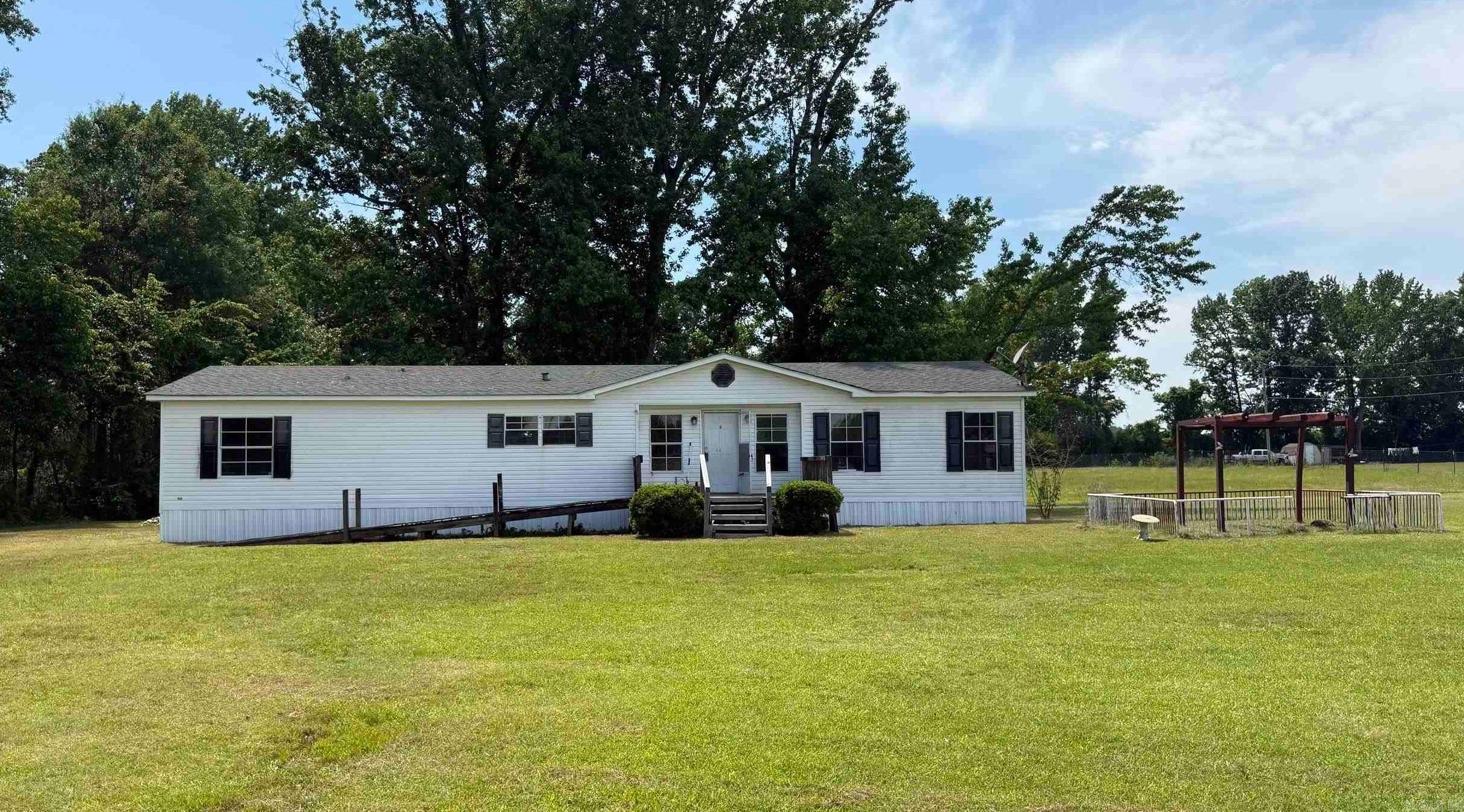 Over 3 acres of budget friendly country living!  This home needs some cosmetic improvements but offers solid potential for investors, renovators, or buyers wanting a home with acreage at an affordable price.  Plenty of room for pets, animals, or a large garden with room to grow!  The backyard is home to beautiful mature shade trees, a nice fenced in area and a separate storage building.  Inside, the primary bedroom features a bathroom suite with double vanities, soaker tub, and separate shower.  Other features of the home include a dedicated kitchen pantry, large laundry room and walk-in closets for storage.