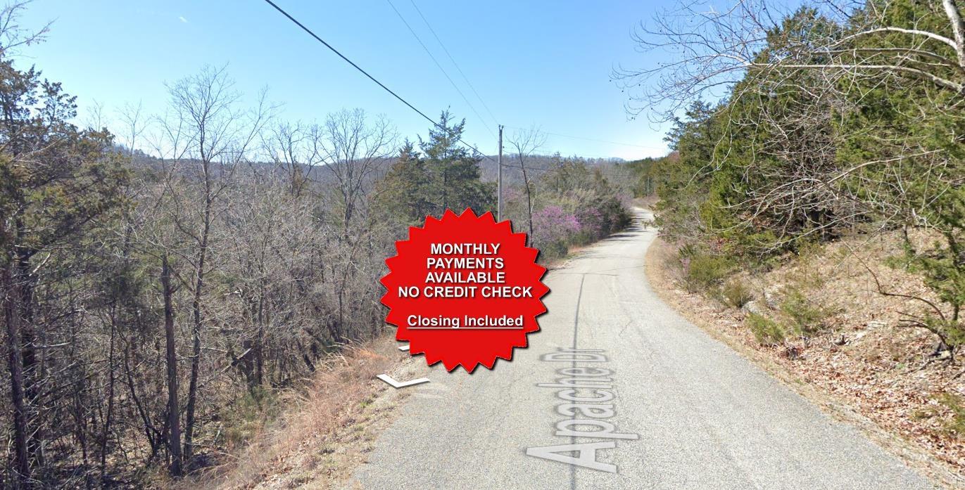 County appraised value $7500. Owner-finance available for easy terms. You cannot camp or park a trailer on the lot. No mobile homes but other types of housing is allowed. Not far from Eureka Springs, the Missouri and Oklahoma border and very scenic mountain area. Public sewer and water at the paved road and electric not far. Nice lot to develop or hold for future value. Owner/agent. Finance is $250 down and $295 a month for 10 months. Quit claim deed conveys. Closing costs are included. Bulk land sales specialist with the best land prices in Arkansas. Over 10 years, as a licensed Realtor, selling land.  Parcel ID# 320-03780-000