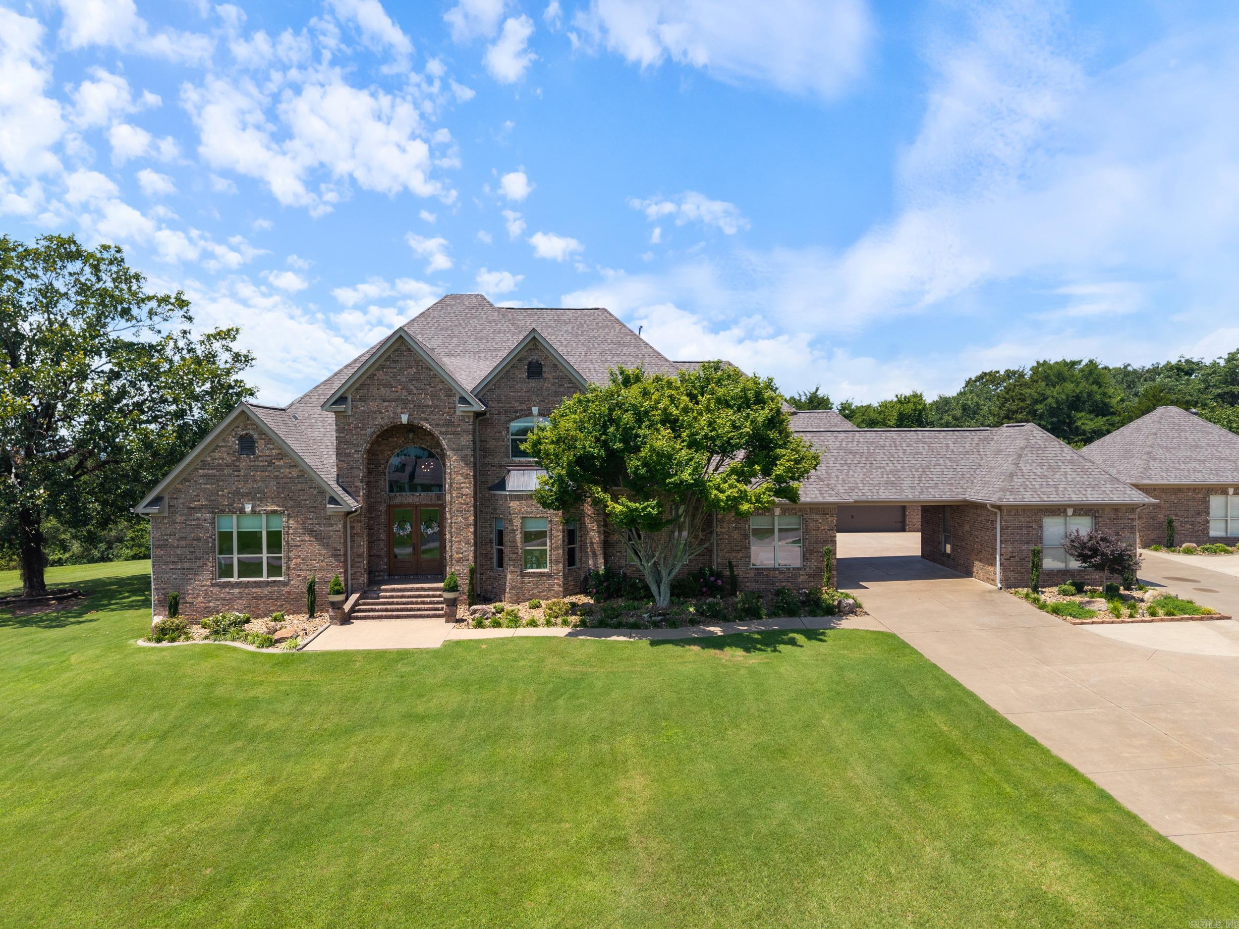 Tucked away on 5 private acres in Woodridge Estates, this exceptional custom home offers space, quality, and thoughtful updates throughout. With approximately 5,886 sq ft, the home features 5 bedrooms, 5.5 baths, including two primary suites, multiple living and dining areas, and a flexible media room that could serve as a sixth bedroom.  Extensive updates and improvements have been completed, including a new roof (2024), updated HVAC, hardwood flooring, interior paint, lighting, windows, and a beautifully refreshed kitchen with granite, custom cabinetry, new appliances, and updated finishes. Both functionality and design have been carefully considered in every space.  Outdoor living is equally impressive, featuring a large pool with recent liner and pump, updated lighting, concrete overlay, and multiple pavilion areas—perfect for relaxing or entertaining. The property also offers extensive landscaping, irrigation, and lighting, along with abundant parking, multiple garage spaces, and a detached shop.  Additional highlights include high ceilings, detailed trim work, gas fireplace, gas cooktop, and a hardlined gas connection for outdoor grilling.