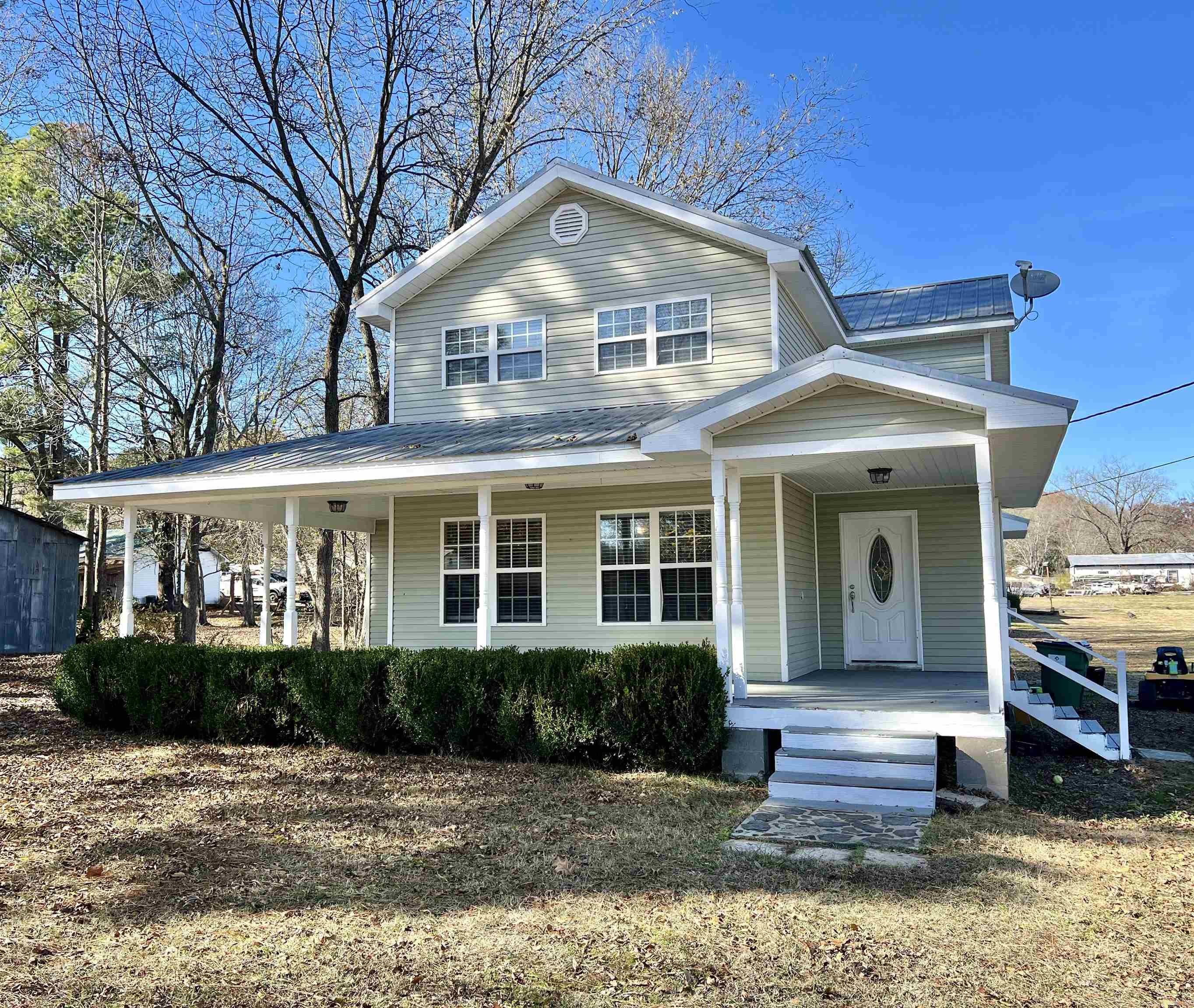 Spacious 4BR/2BA, 2060 sq ft home, built in 2007, on a 1/2 acre, corner lot in town. Convenient to the medical center, grocery store, post office and park, as well as just a few minutes to several Little Red River access points. This two-story, stylish house has a charming wrap-around porch, ideal for a front porch swing or plenty of space for outdoor furniture. Downstairs offers the primary bedroom with adjoining office space and/or additional storage, while upstairs hosts three spacious bedrooms and a full bath. The separate laundry room is a generous size with an industrial style sink, this room would make a great area to add shelving for extra pantry storage as well. The metal roof adds durability to this welcoming residence, providing a perfect blend of comfort and style. Check it out!