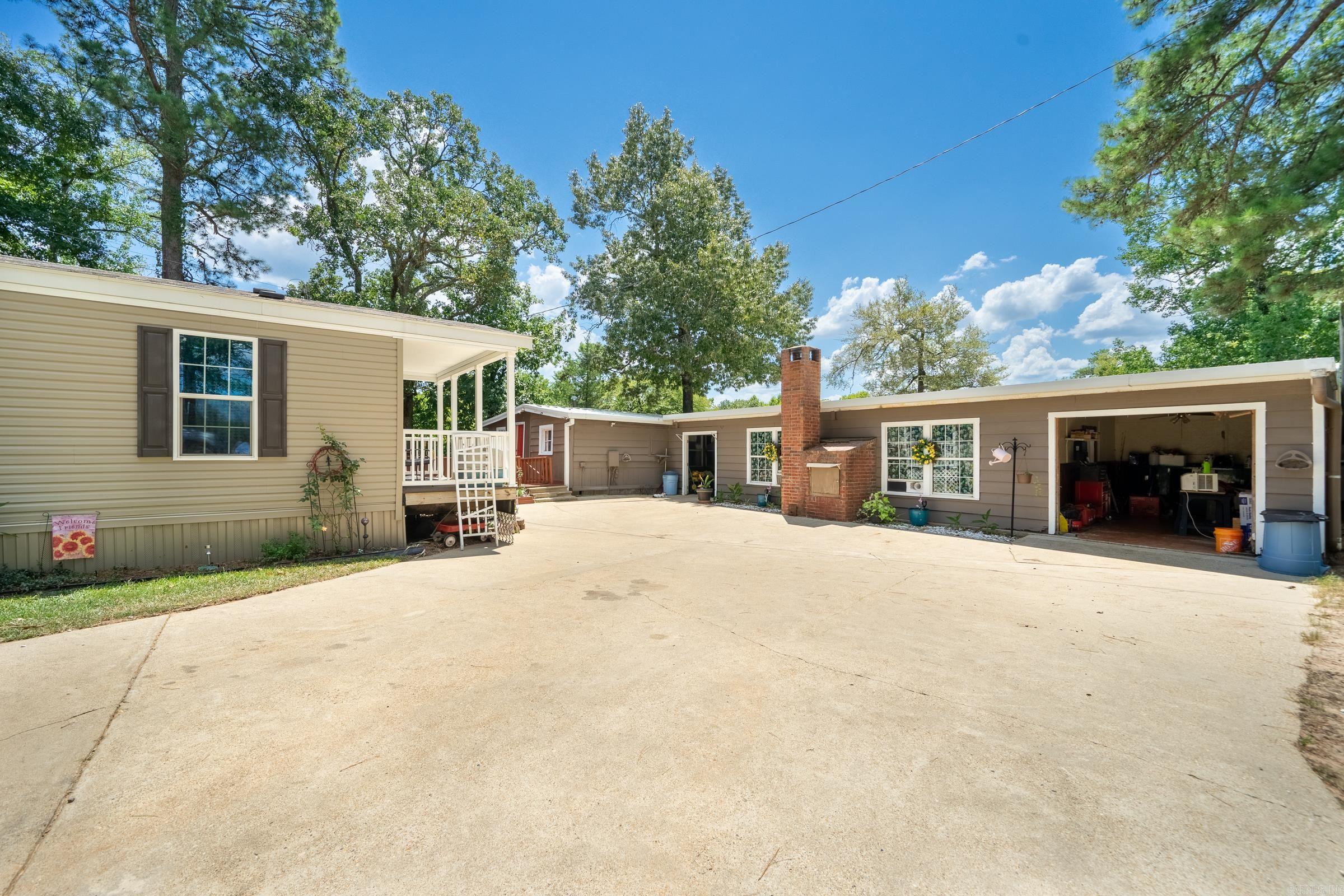 One of a kind place on the Cossatot River!   Two separate dwellings all with breathtaking views and a wraparound porch! Perfect for future vacation rentals or your weekend getaway. First home is a 1999 Mobile home with 2556 sqft.  3 bedrooms 2 baths with a new Generac generator propane tank in Spring of 2024.   Second home is a 2016 Mobile home with 896 sqft 2 bedrooms 1 bath.