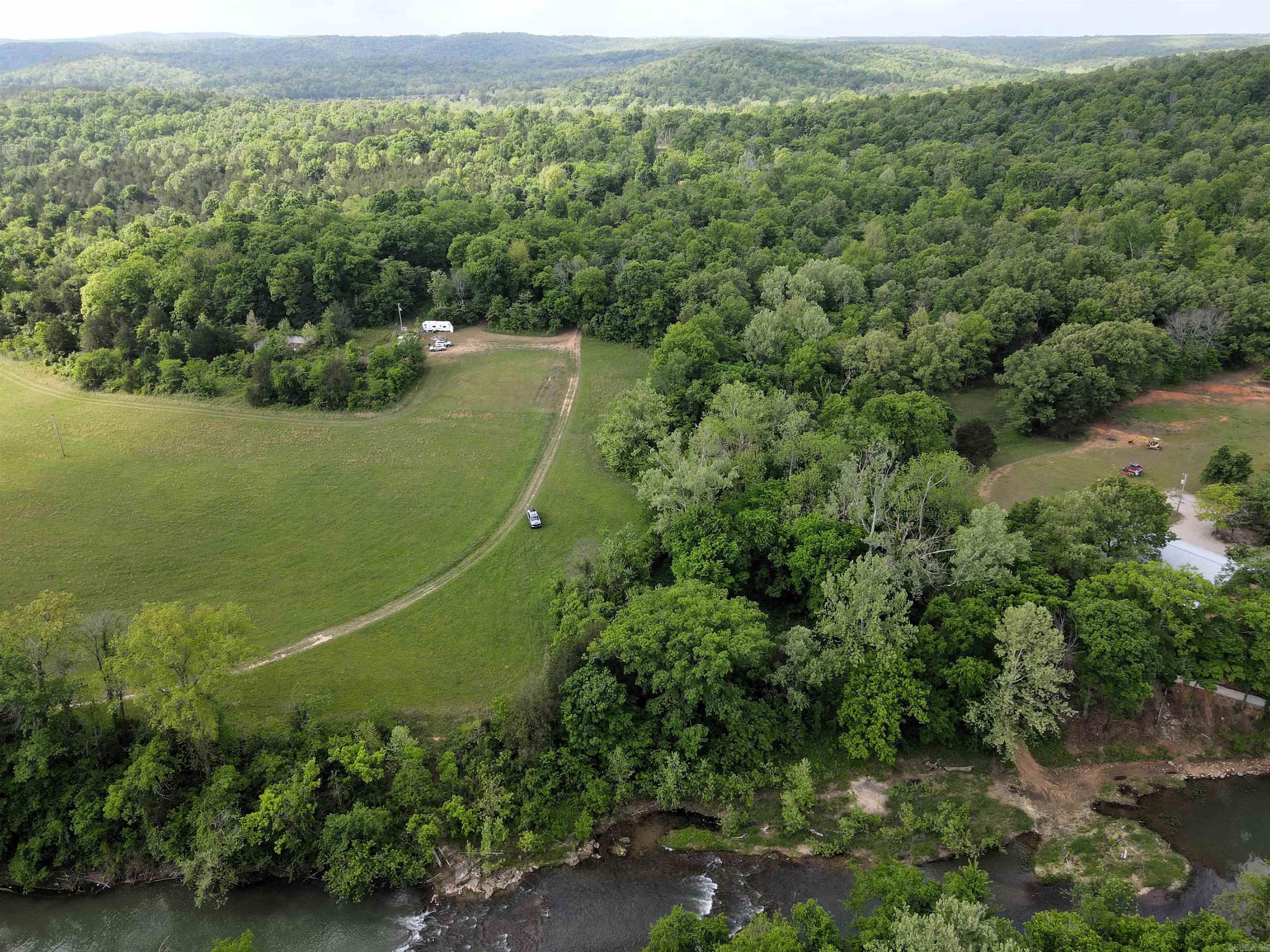 - River Road frontage - 200' of Spring River frontage - Electricity & public water along the county road - 3 +/- acres of pasture - 6 +/- acres of mature mixed timber - 1/3 mile from Harold E Alexander/Spring River WMA - Numerous build sites - Great hunting - Exceptional smallmouth fishing - 13 miles to Ash Flat - 7 miles to Hardy