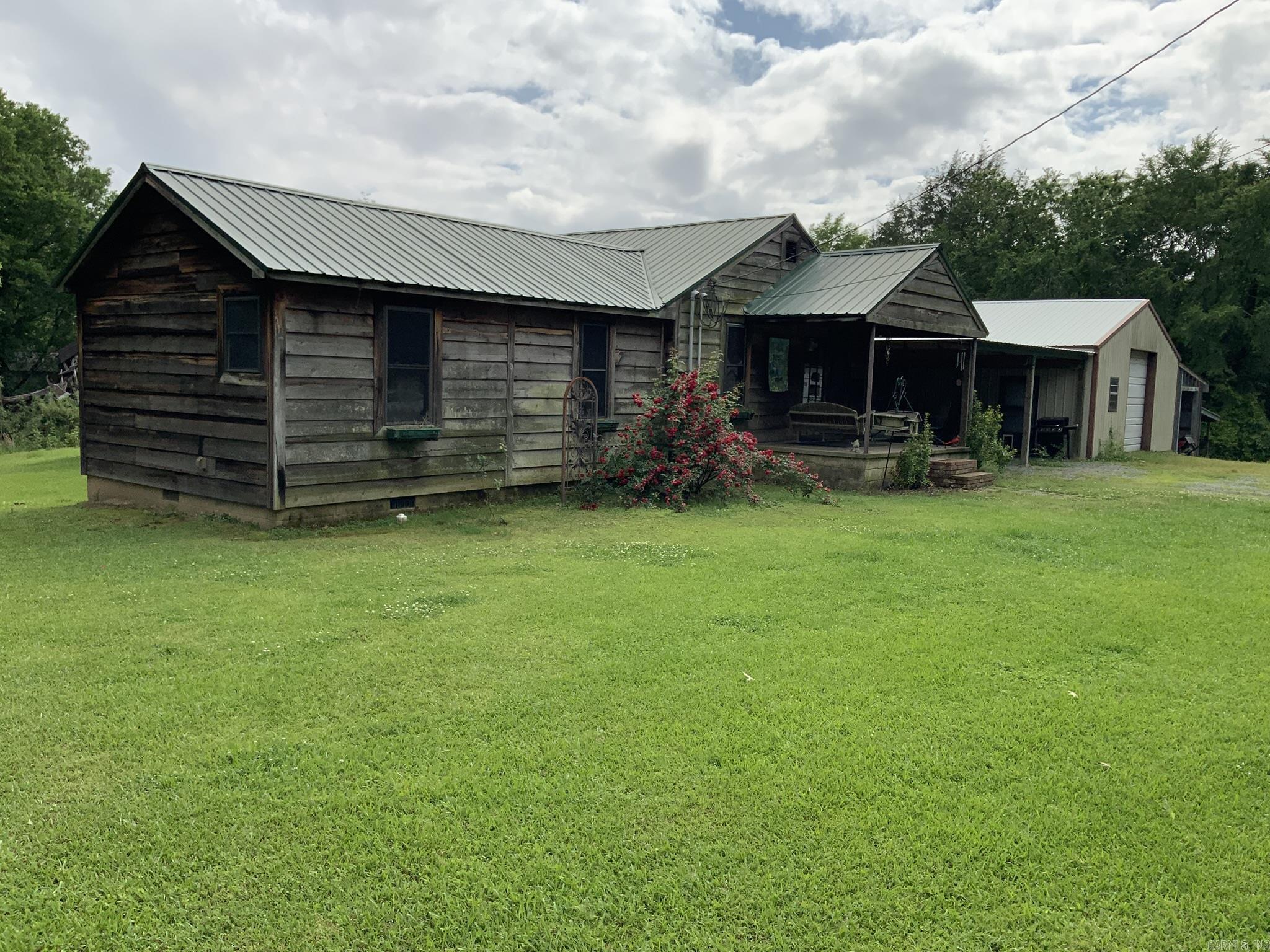 Country home sits on 40 acres:  This country home has 3 bedrooms,2 baths 1656 sf.  Updates to include tongue and groove ceiling and walls throughout the home, laminate flooring and tile in the baths updates approx. 6 years ago.   There is a covered deck.  New metal roof approx. 6 years old.  Nice shop approx.  30x40 with electricity and a full bath.  Great property for deer hunters.  Also close to the White River for fishing or duck hunting.  Property is SOLD AS IS.  (Also to include 6 additional parcels )  All parcels to be sold together, seller will not sell parcels separately.)  See confidential remarks for additional parcels.  ** Acreage is approx. until a survey is conducted.**