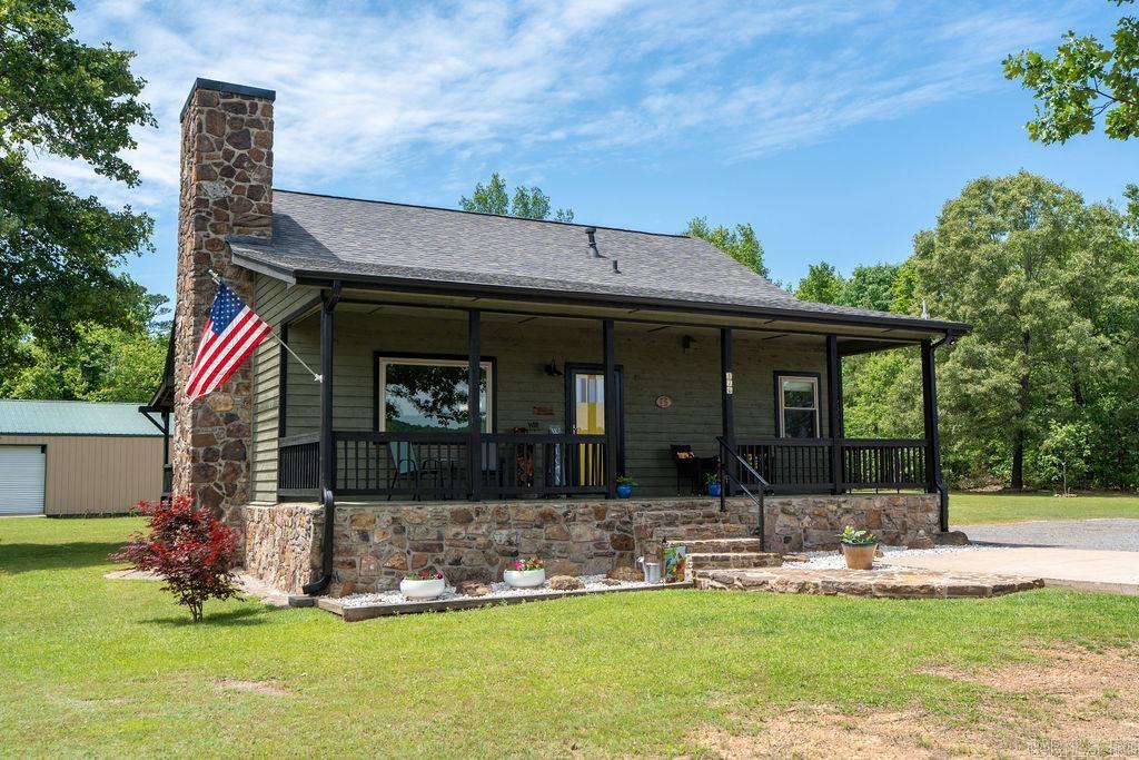 This beautiful, newly renovated 1,156 sq ft Craftsman-style cabin offers 2 bedrooms and 1 bath, combining rustic charm with modern upgrades in a very spacious home that is meticulously kept both indoors and outdoors. The open floor plan is perfect for relaxing or entertaining, featuring a main living area with durable LVP flooring. The updated kitchen showcases new granite countertops, a gas cooktop stove, new fixtures, and a new sink, flowing seamlessly into the living space. The bathroom has been tastefully remodeled with a new marble top vanity, new sink, and updated fixtures. Additional improvements include a roof less than 7 years old, new windows, an updated back deck, and fresh paint inside and out, making this home truly move-in ready. Outside, you’ll find a 30’x40’ shop with two roll-up doors—ideal for lake toys, vehicles, or additional workspace—along with a charming garden shed with shelving and a work counter. The property also features 50 amp RV service and plenty of land for expansion. Located just 0.6 miles from Tannenbaum Golf Course and minutes from the lake, this property offers the perfect blend of comfort and resort-style living.