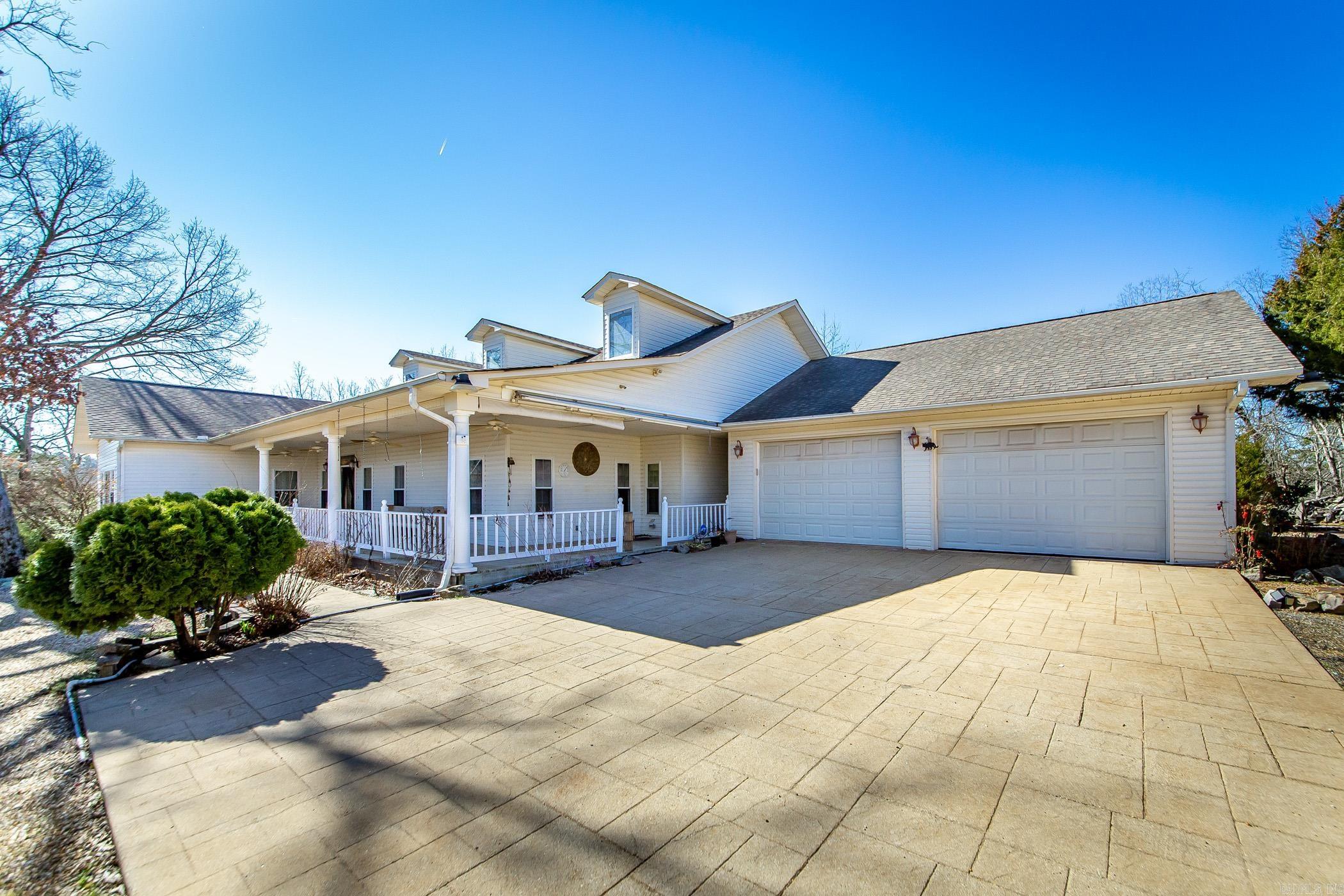 Discover privacy, acreage, and endless potential with this 16.78-acre estate near Hot Springs, ideal for a family compound, multigenerational living, private retreat, or investment property. The 3,112 sq ft home offers spacious rooms, an open great room, breakfast nook, formal dining room, and a large covered back porch perfect for entertaining and outdoor living. A rock fountain creates a peaceful backyard setting for relaxing evenings. The primary suite features an ensuite bath and private sunroom with hot tub, creating the perfect personal retreat. A versatile guest room includes a built-in desk and Murphy bed, ideal for a home office, remote work space, or guests. Property includes four additional buildable homesites with utilities available, plus an additional 3.13-acre parcel with foundation already in place, offering incredible potential for guest homes, vacation rentals, Airbnb/VRBO potential, or future development. A large shop building provides space for hobbies, equipment, or workshop use. Enjoy peaceful country living with acreage and privacy just minutes from Oaklawn Racing Casino Resort, Bathhouse Row, downtown Hot Springs, lakes, dining, and entertainment.