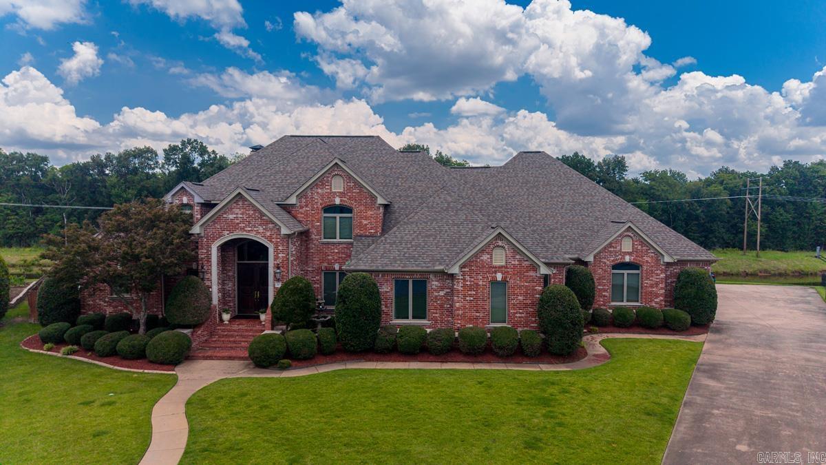 Stunning custom home in West Little Rock’s premier neighborhood, The Ranch. This 5-bed, 4.5-bath estate backs directly to the river for instant kayaking and canoeing. The Ranch offers a private nature reserve, 2 fishing ponds, a boat launch, and a playground. The main-level open floor plan  living room flows to formal dining, office, renovated chef's kitchen featuring granite counters, new appliances, and a pantry. The kitchen opens to a hearth room with a gas log fireplace. Spacious primary suite boasts a jetted tub, walk-in shower, dual sinks, and a walk-in closet. The main level includes 2 additional bedrooms, 2 full baths, and a half bath. Upstairs features 2 guest bedrooms, full bath and a massive game room with unfinished space. The resort-style backyard retreat features a covered porch, saltwater pool, and outdoor bar with a pool bathroom. Extras include a mudroom, laundry with sink, safe room, and a 4-car garage.  Updates roof 2021, HVAC 2023, windows 2021,2 downs stairs baths 2022, water heaters 2022, pool pump 2026 and liner 2025.  Flood Insurance not required.